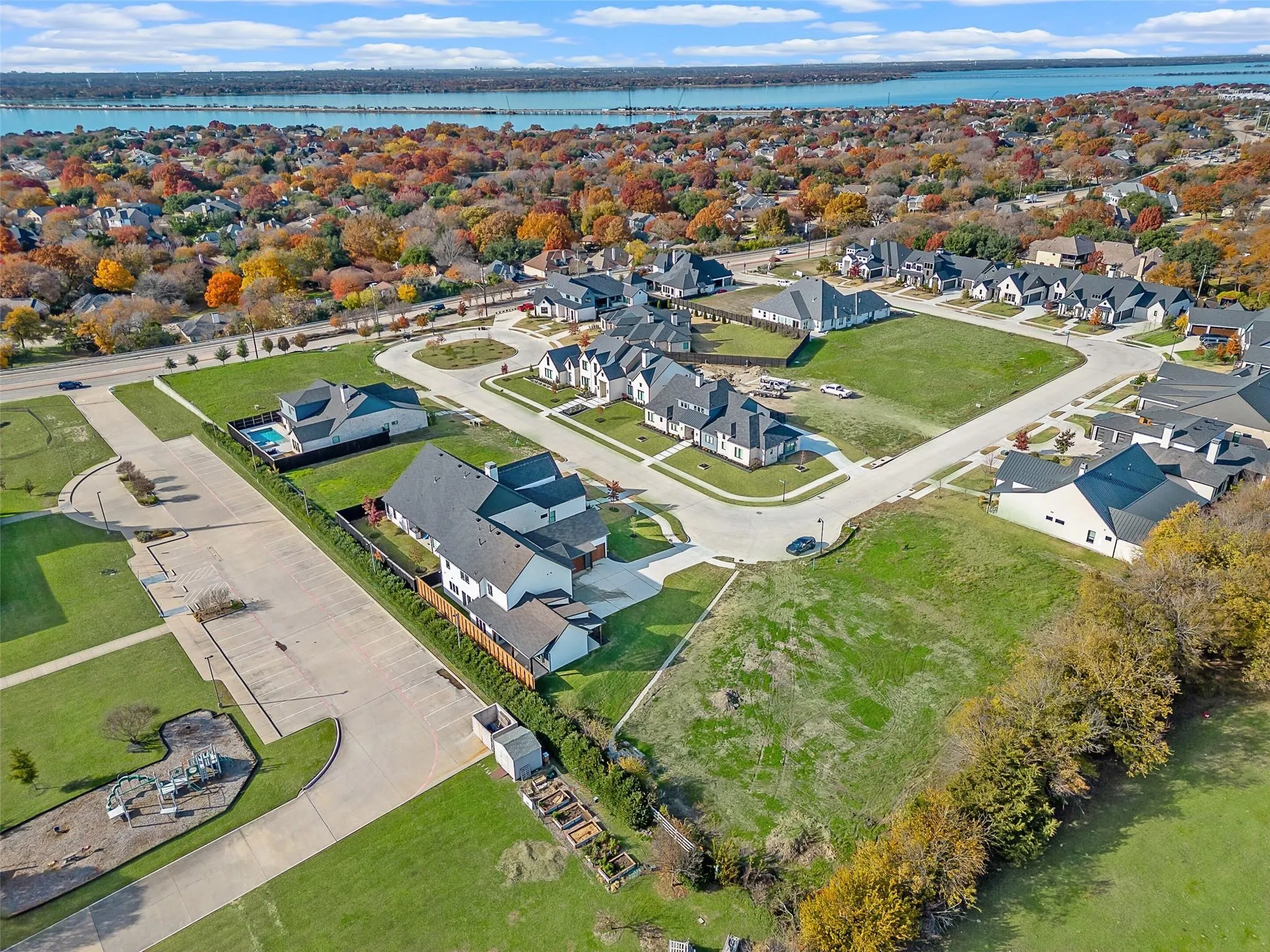 Spacious residential community with varied architectural styles, green spaces, and paved roads