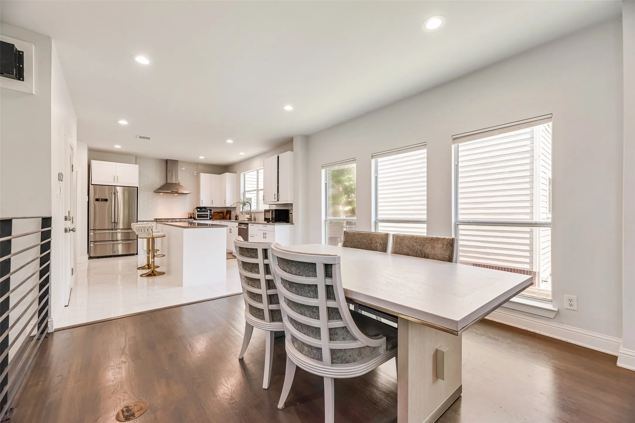 Open-concept dining area with dark wood-finish flooring