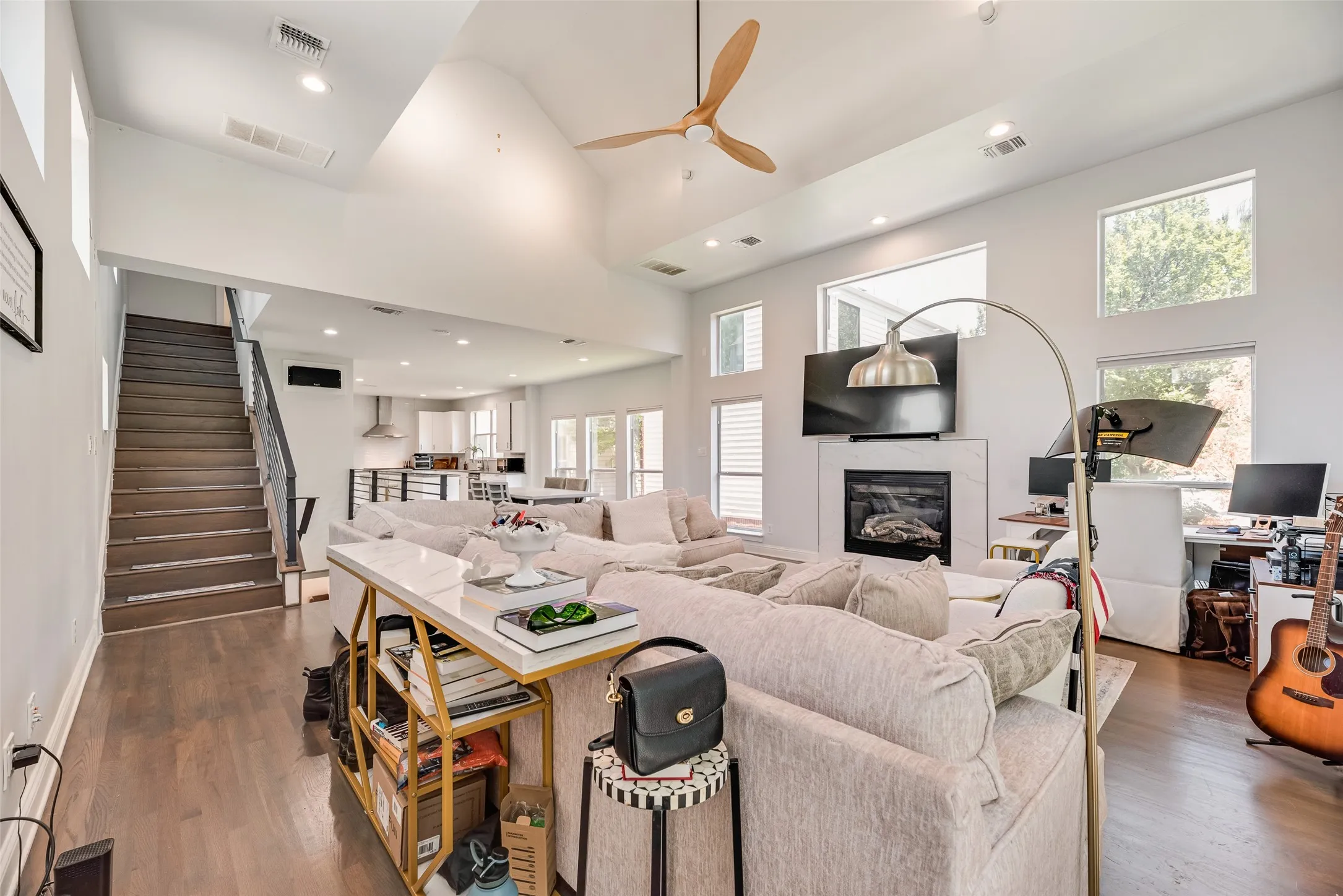Spacious open-concept living area featuring high vaulted ceilings, recessed lighting, and wood-finish​​‌​​​​‌​​‌‌​‌‌​​​‌‌​‌​‌​‌​​​‌​​ flooring