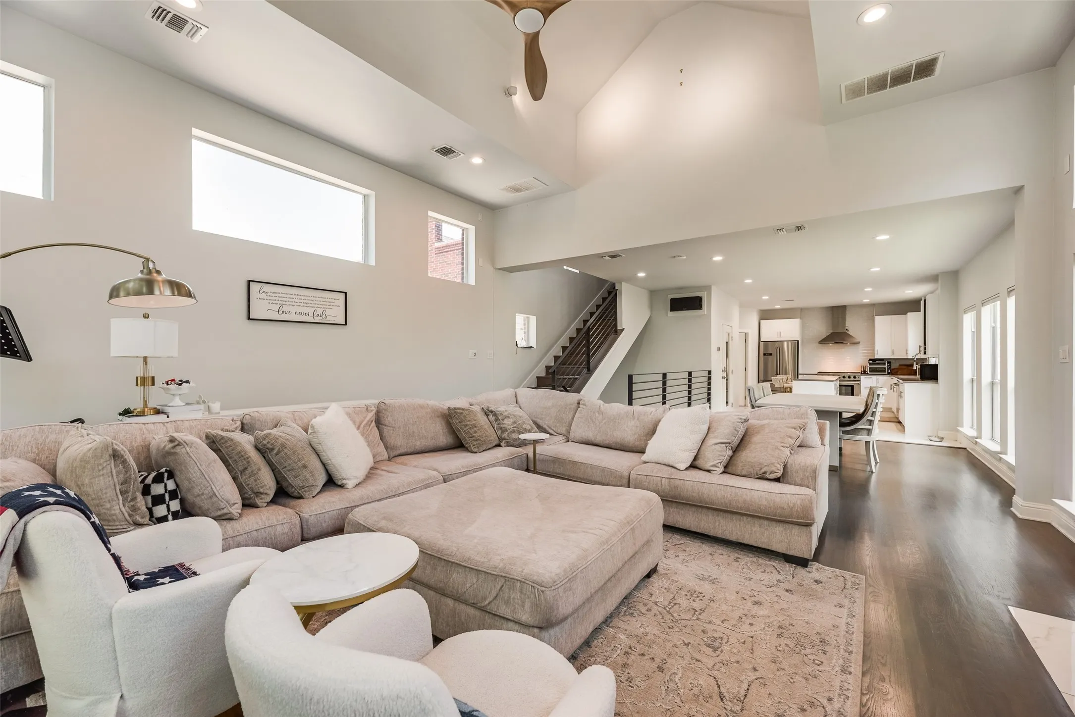 Expansive living area featuring soaring ceilings and dark wood-finish flooring