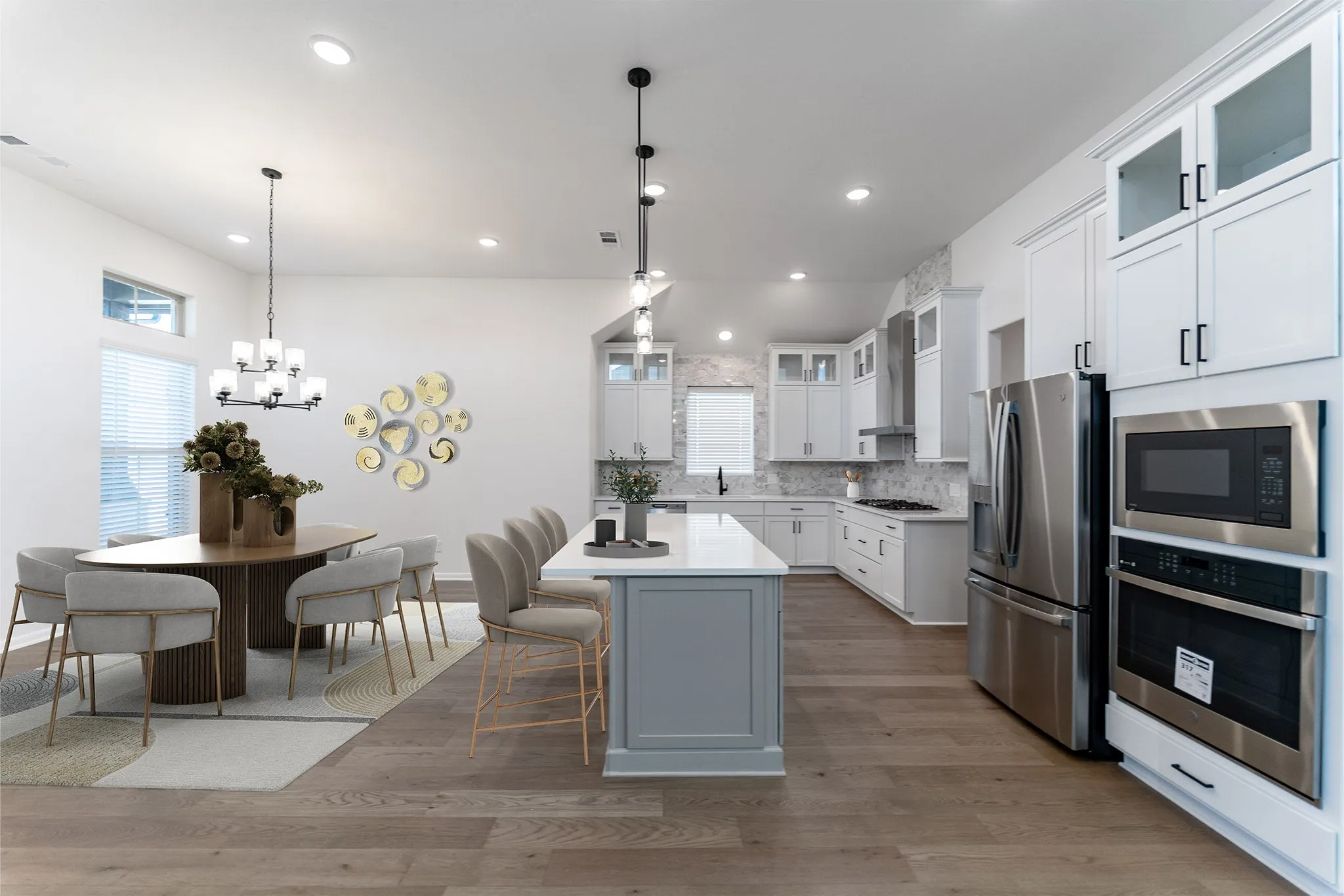 Open-concept living space featuring wood-finish flooring, recessed lighting, and a modern chandelier