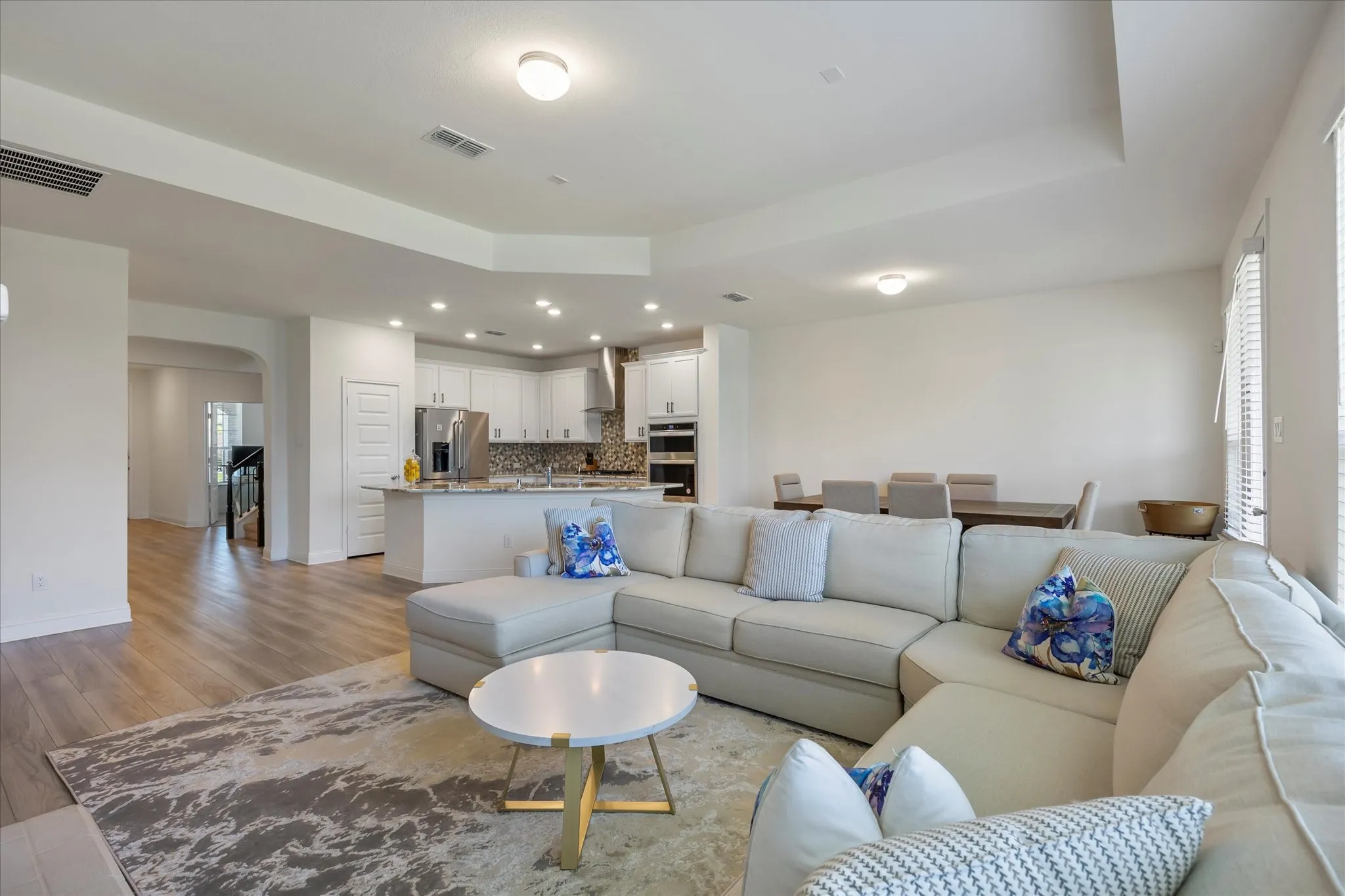 Spacious family room overlooks kitchen and dining area