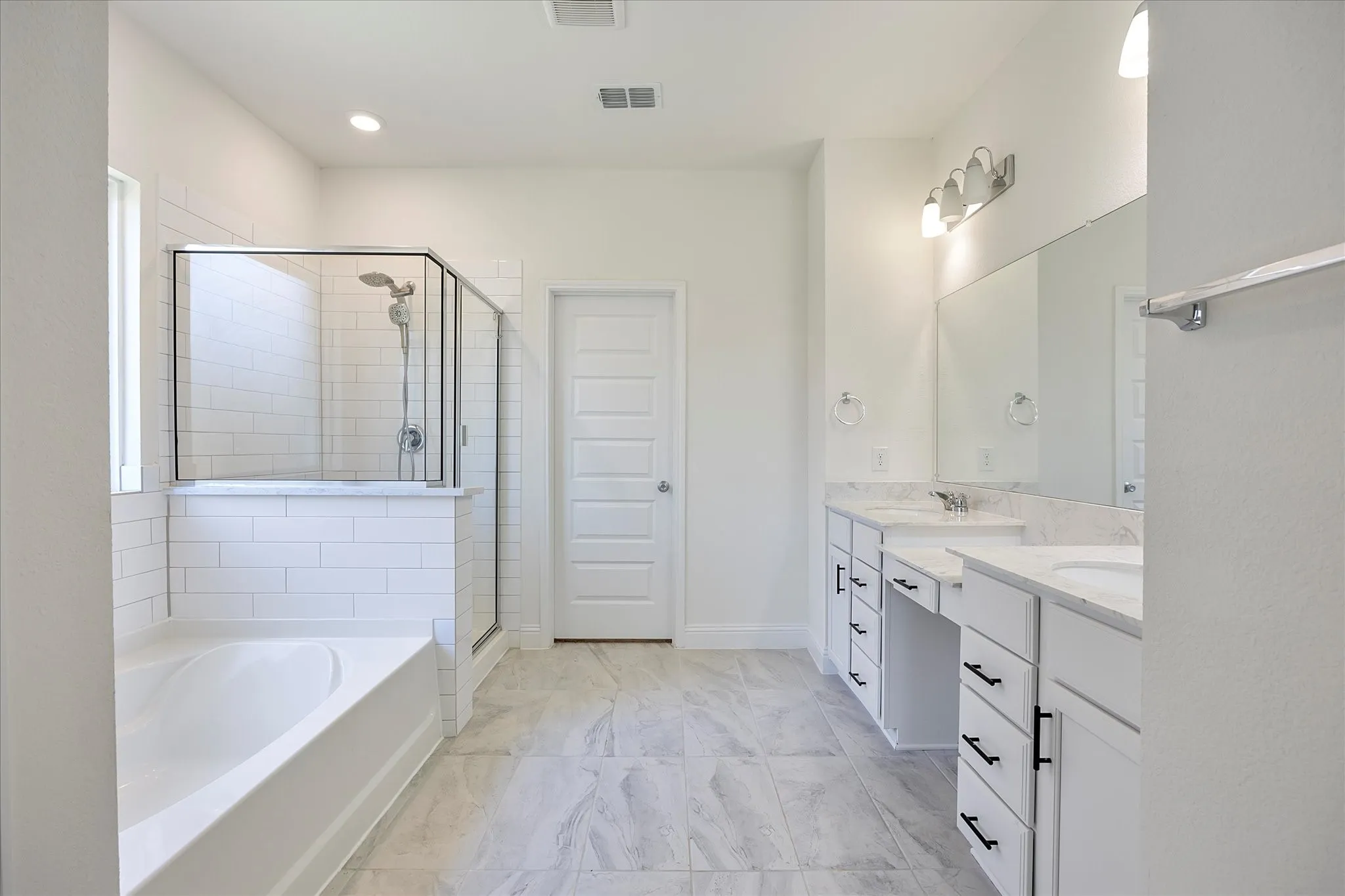 Gorgeous master bath includes garden tub and separate shower.