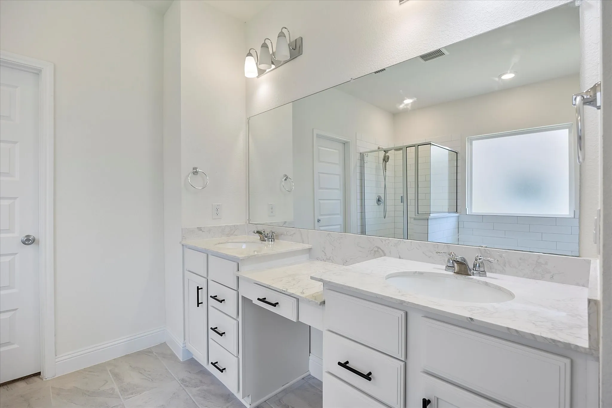 Master bath includes his and her vanities with make up area and walk in closet