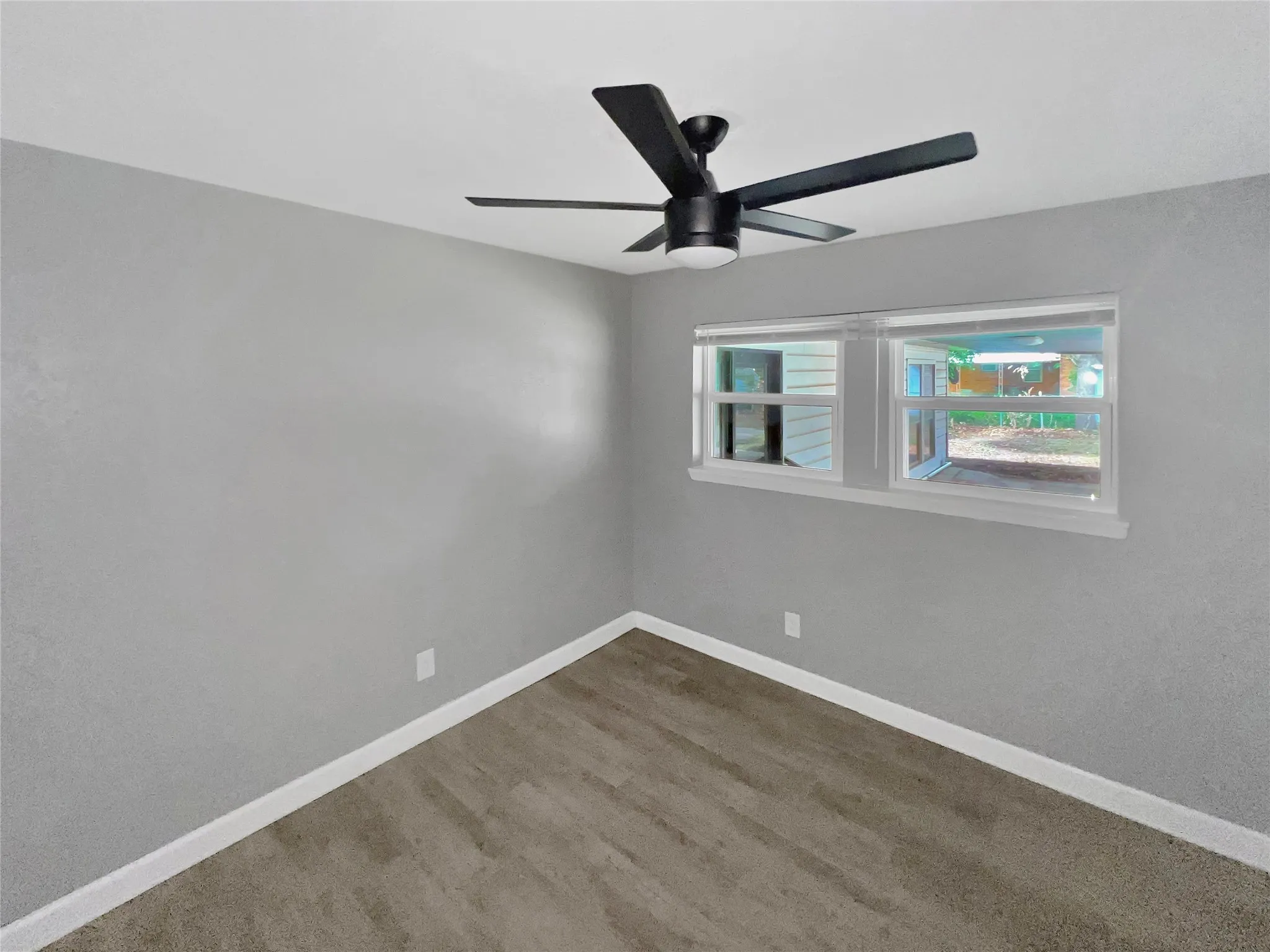 Room featuring light gray painted walls and wood-finish flooring