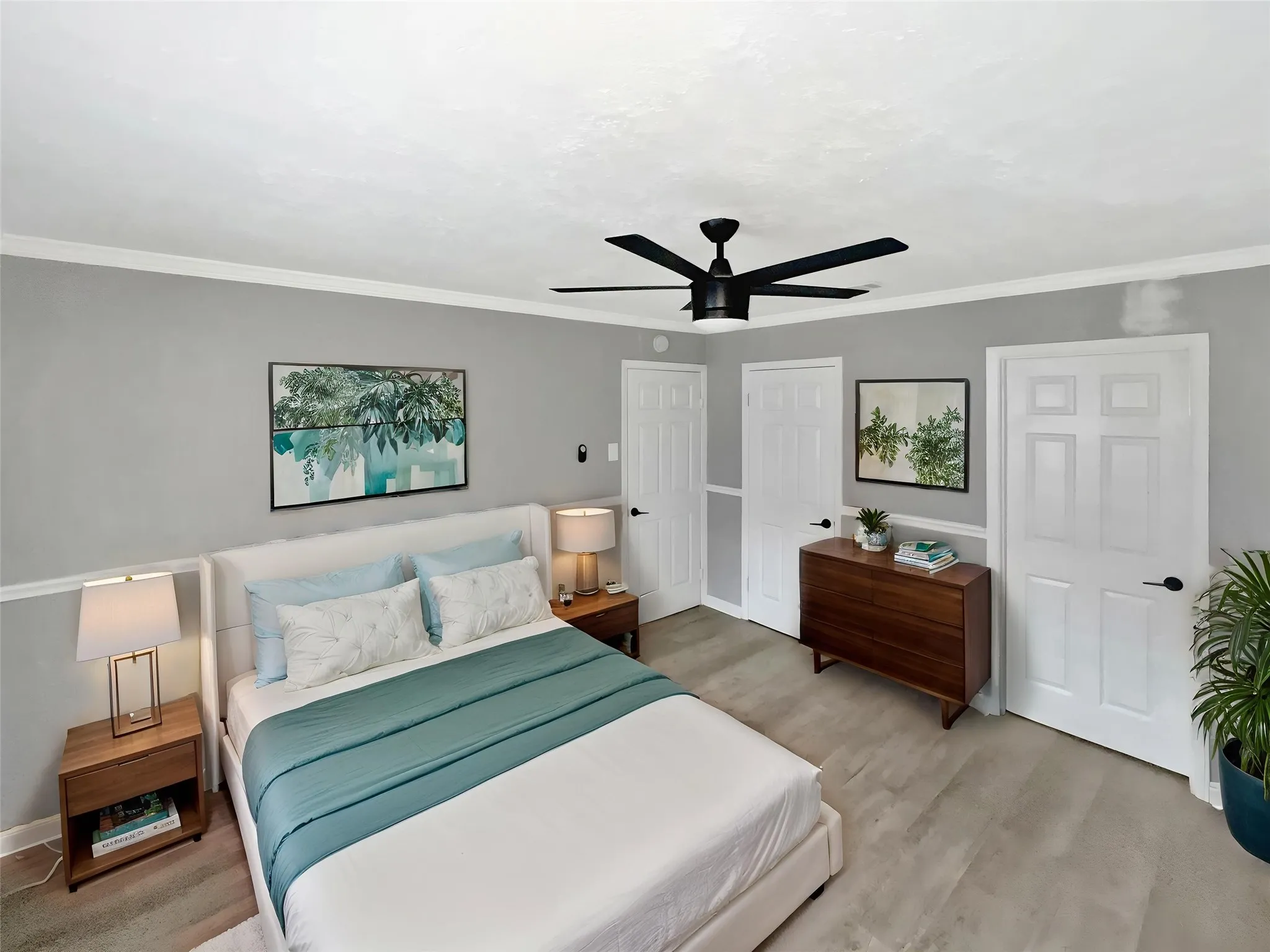 Virtually staged
Bedroom featuring a matte black ceiling fan, crown molding, light gray walls with wainscoting, and wood-finish flooring