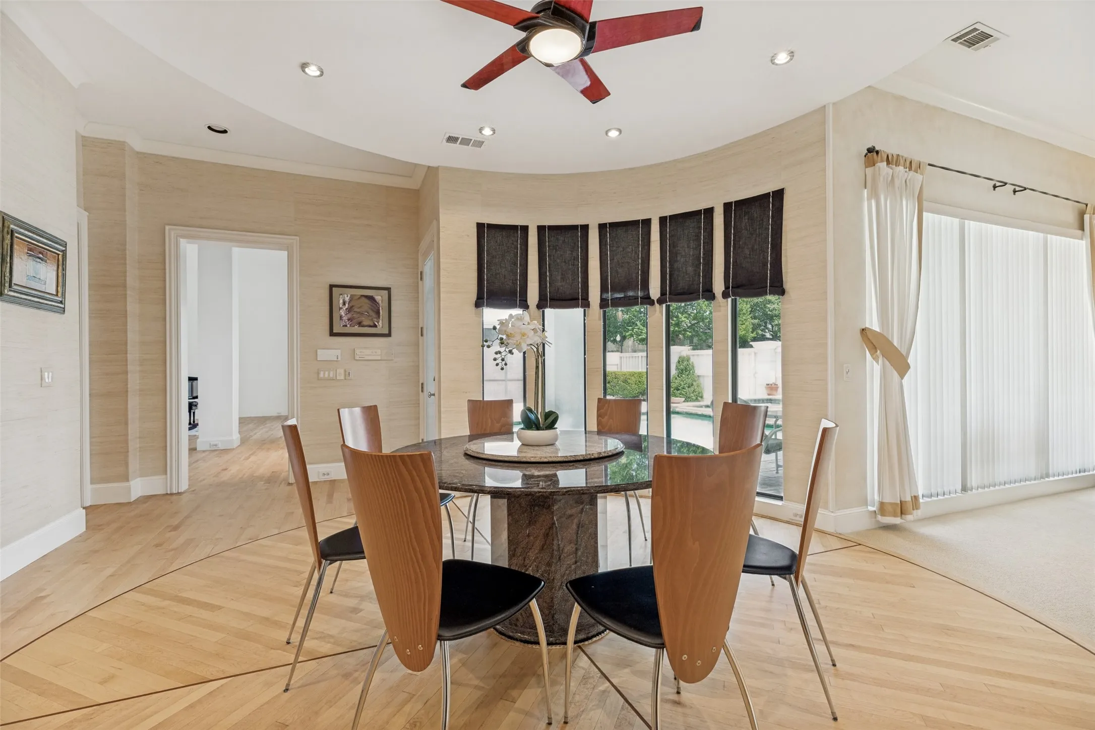 Dining area featuring a curved wall of large windows overlooking the exterior