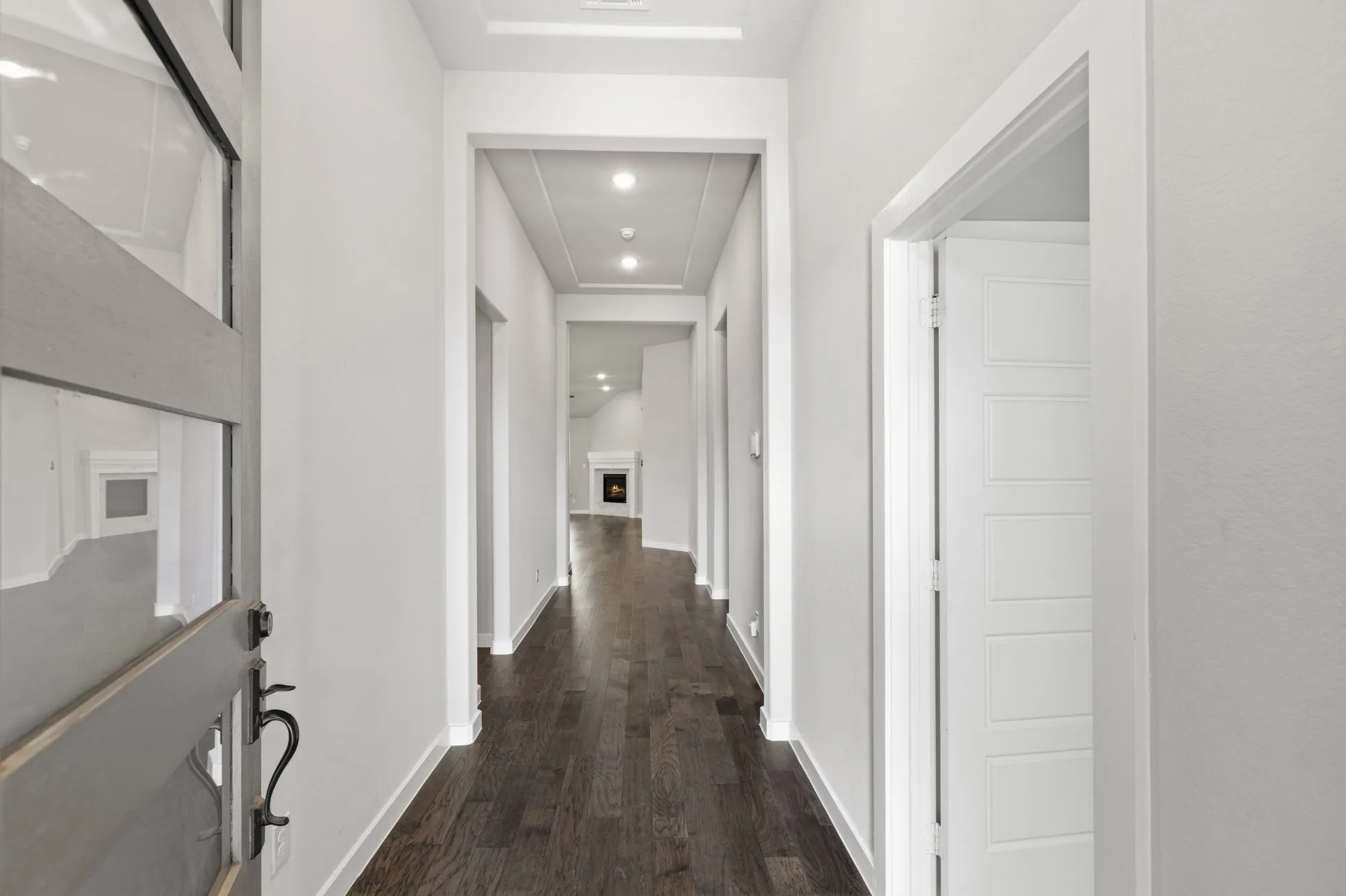 Entryway featuring dark wood-finish flooring, white walls, and recessed lighting