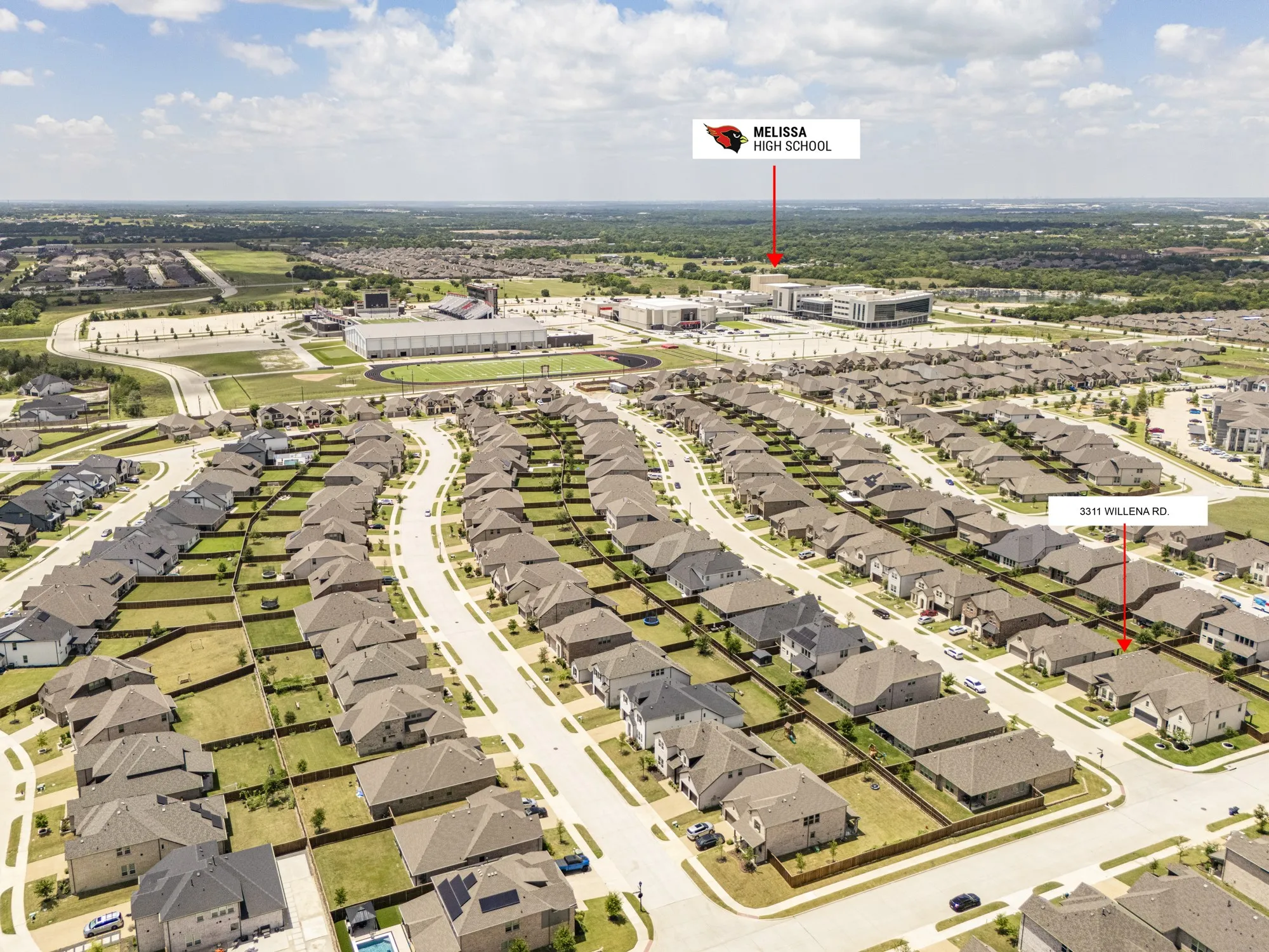 Aerial perspective showcasing a residential neighborhood with numerous single-story and two-story homes featuring tan and gray exteriors and dark roofing
