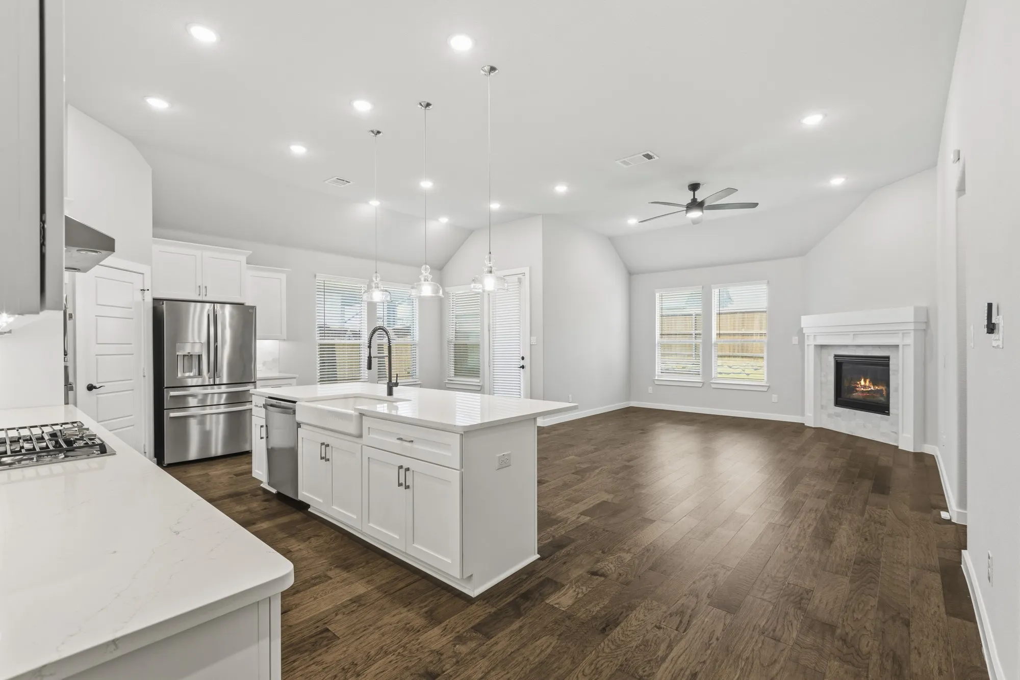 Open-concept living space with wood-finish flooring