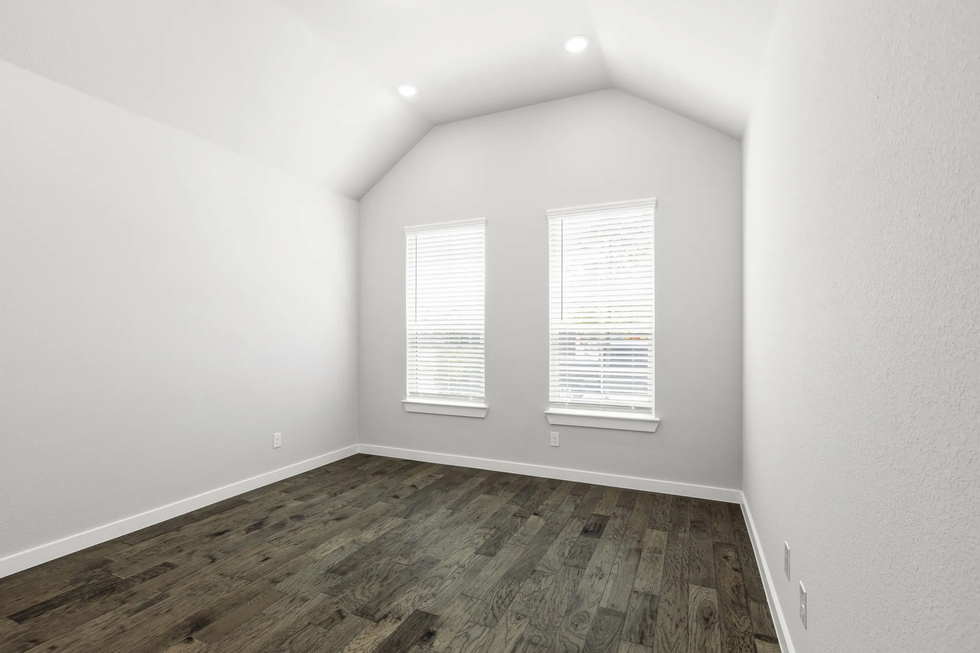 Vaulted ceilings enhance this room featuring two windows with blinds, recessed lighting, and wood-finish flooring
