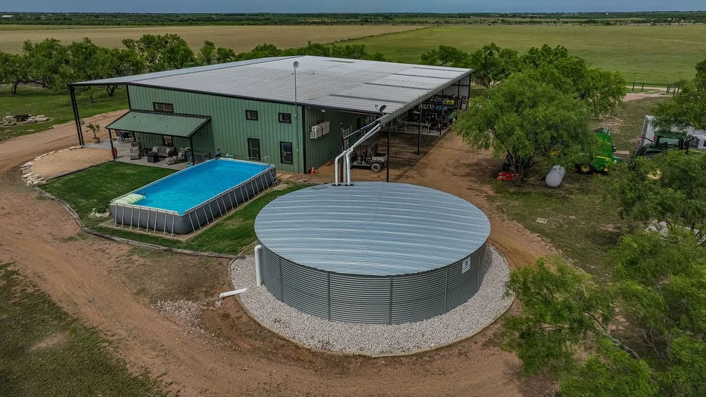 A 40,000 gallon rainwater collection system feeds the home, with guttered metal roof catchment. It's a reliable water source for off grid living on Texas ranch land.