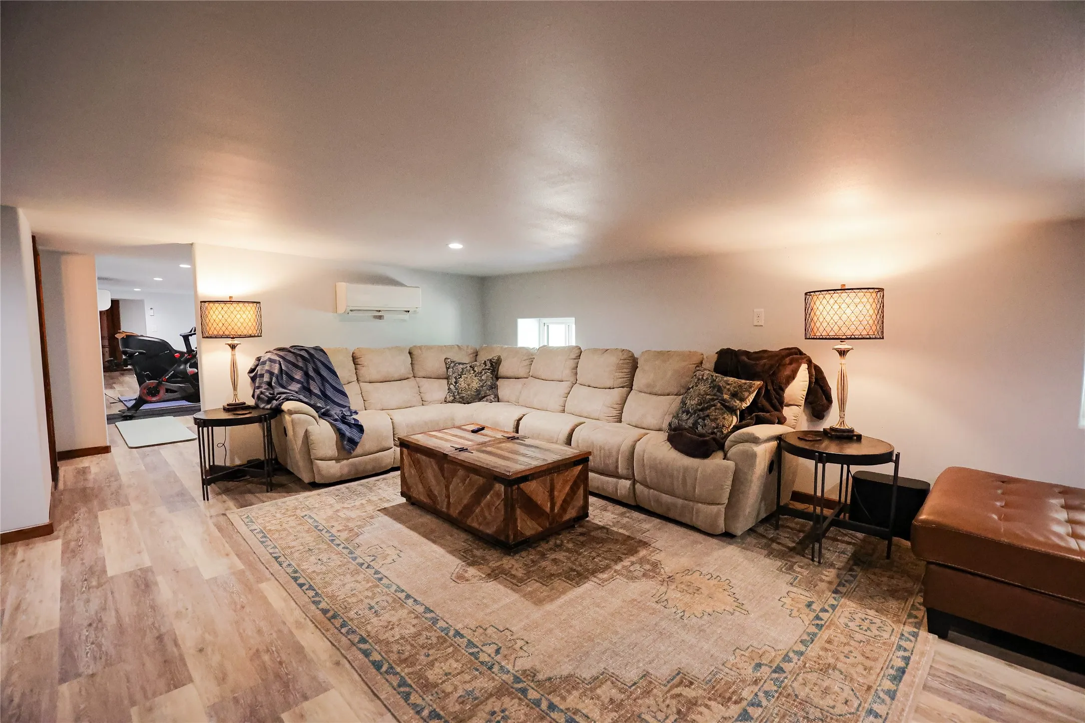 Media room with space for a large sectional, movie nights and game day gatherings. It's one of several living areas in this 6,300 sq ft barndominium on 283.98 acres.