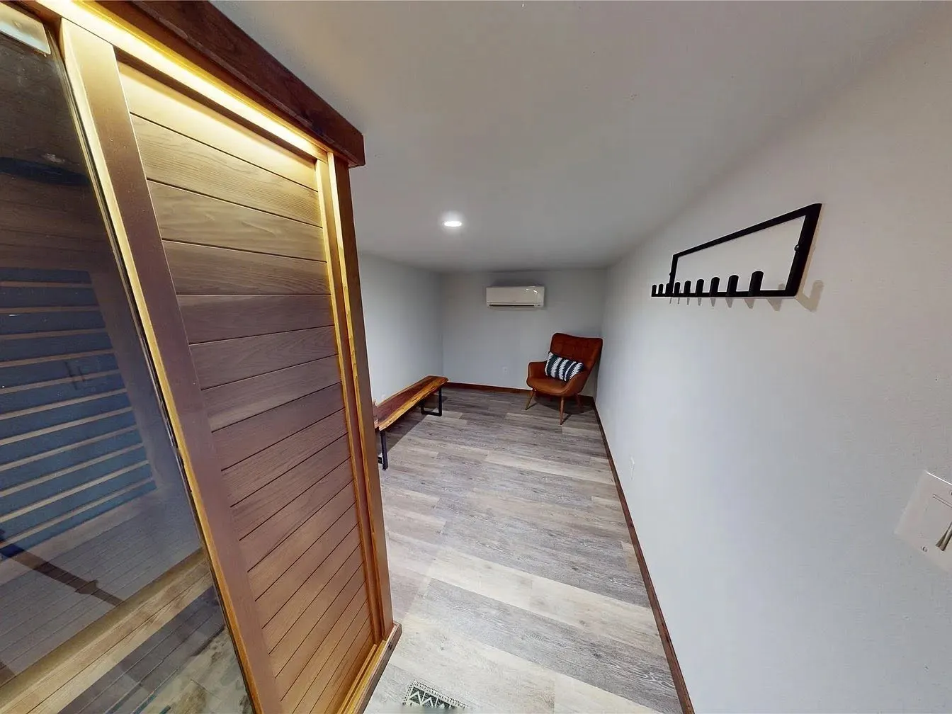Indoor wood sauna with a glass door and an adjoining cool down lounge. It's a spa feature rarely found on Central Texas ranch properties for sale.