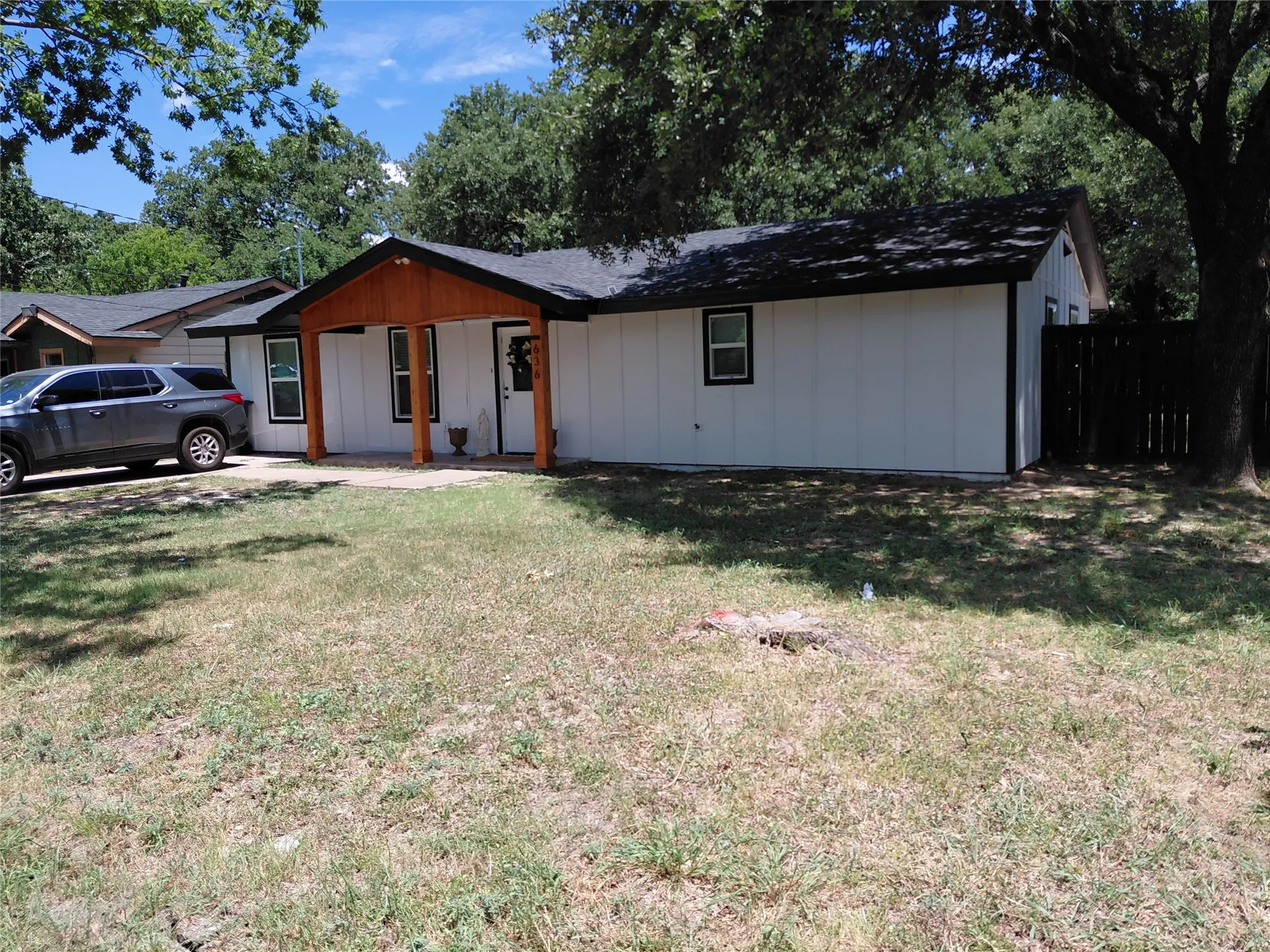 White vertical siding exterior with black trim windows