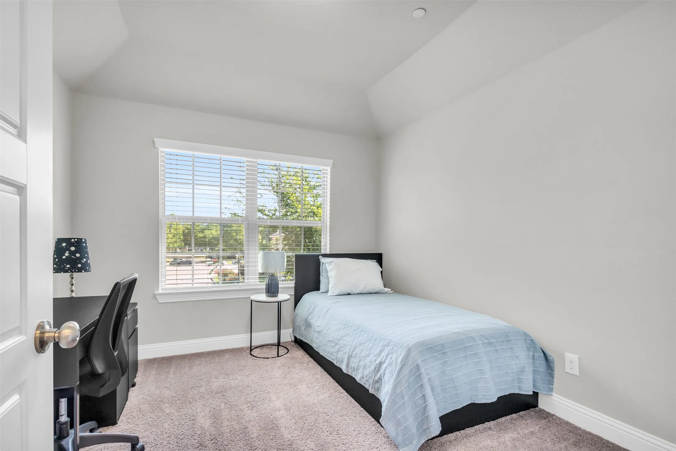 Carpeted room with a large window featuring white blinds, crown molding, and a built-in architectural ceiling detail