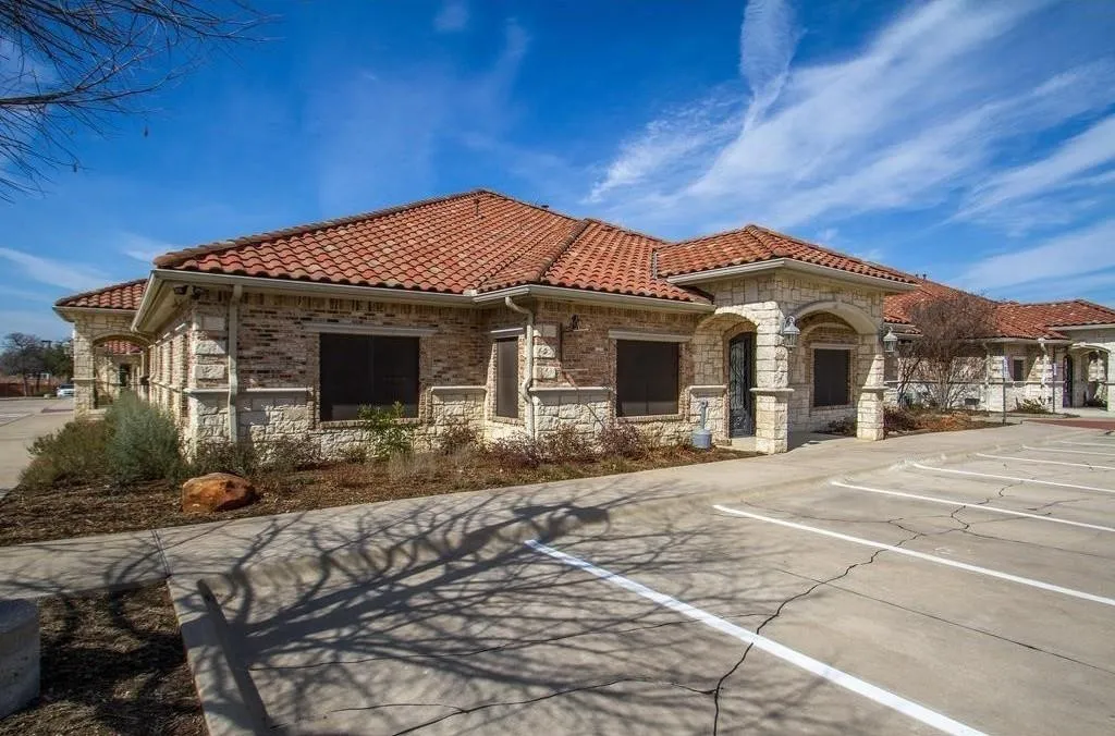 Exterior featuring a red tile roof and stone facade