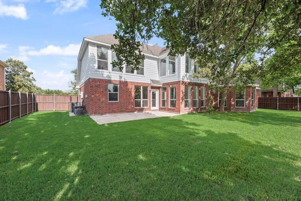 Stunning brick and siding exterior featuring an uncovered patio