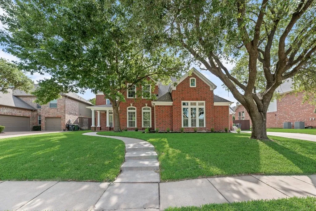 Beautiful brick exterior with mature trees