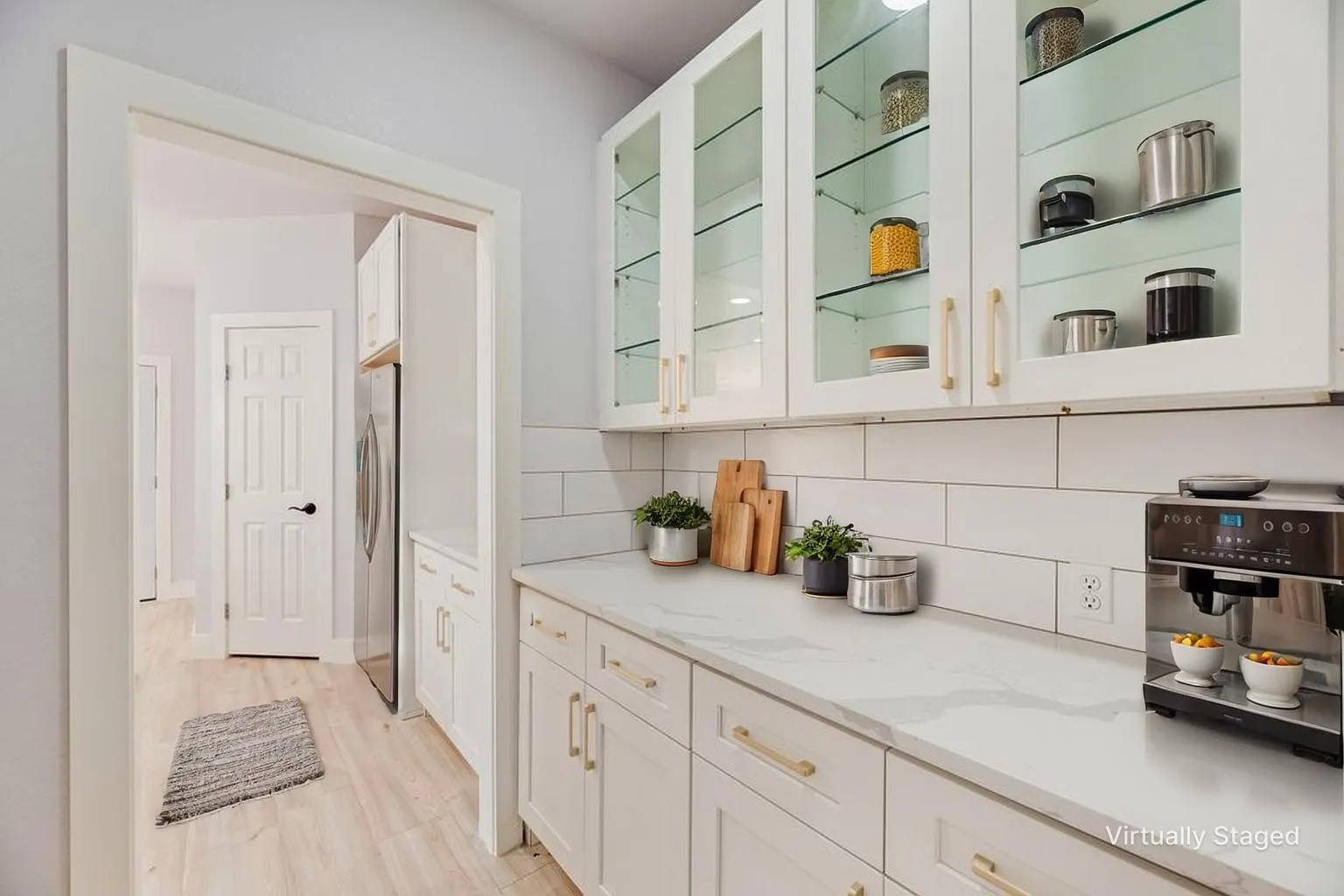 Butlers pantry featuring elegant glass-front upper cabinetry and timeless subway tile backsplash
