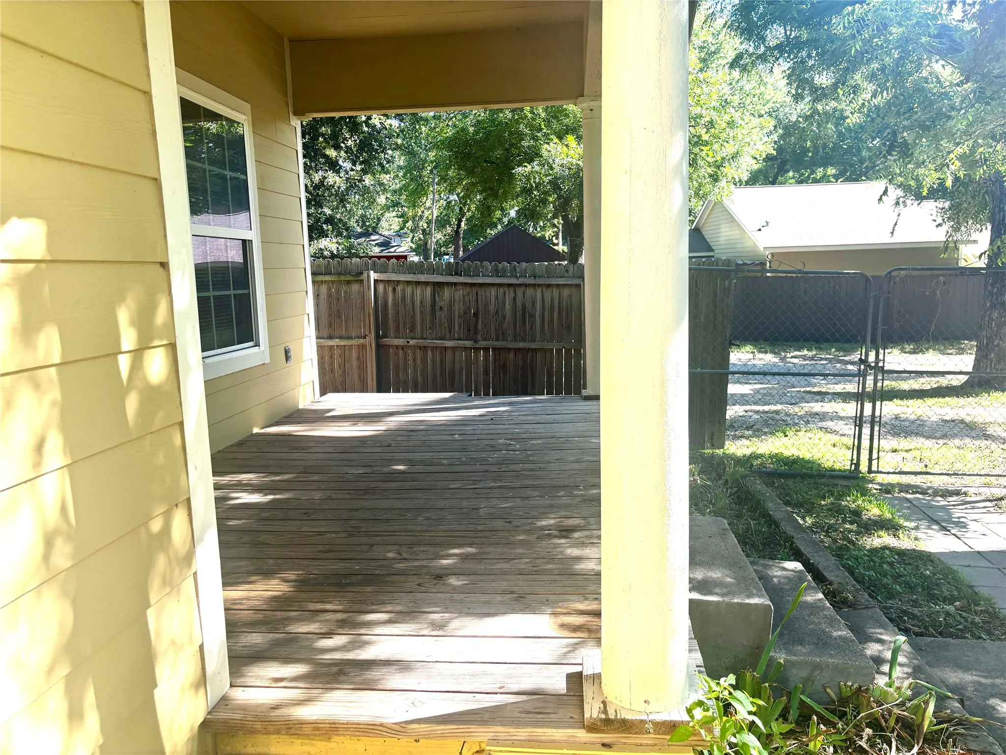 Covered wooden deck with siding exterior