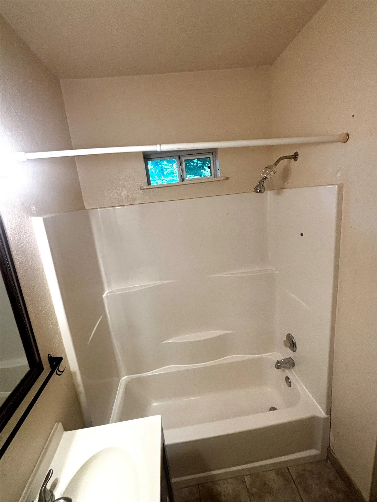 White tub and shower combination unit featuring chrome fixtures