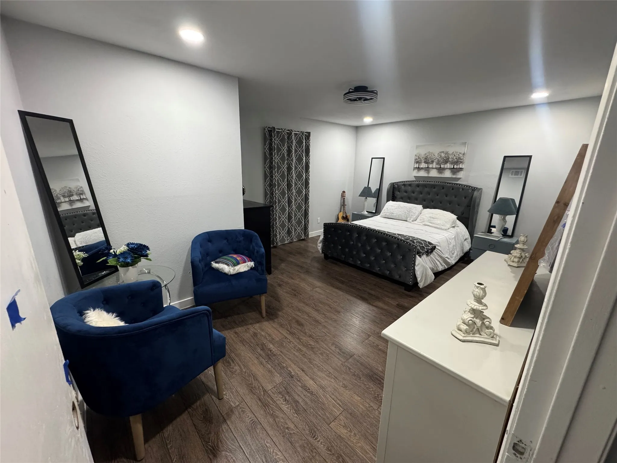 Spacious interior room featuring wood-finish flooring, recessed lighting, and light gray wall paint