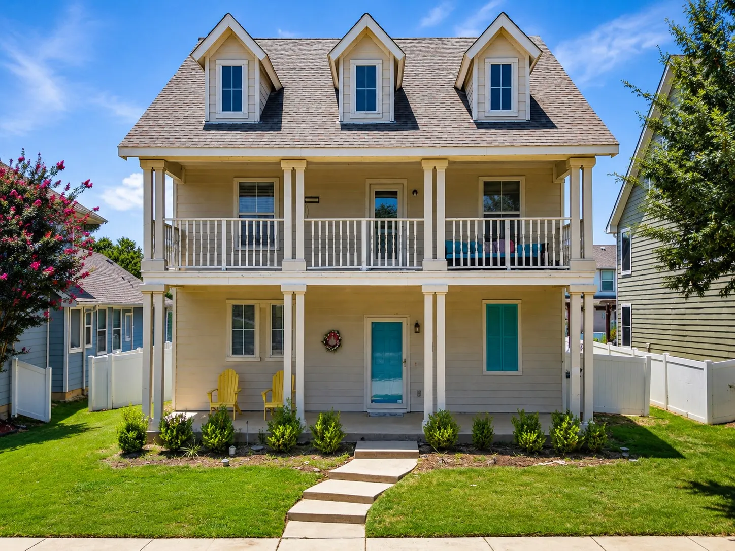 Two-story residence featuring a covered front porch and second-story balcony
