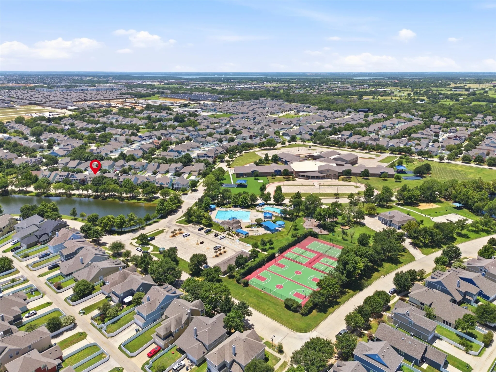 Aerial perspective showcasing a residential community with a central lake