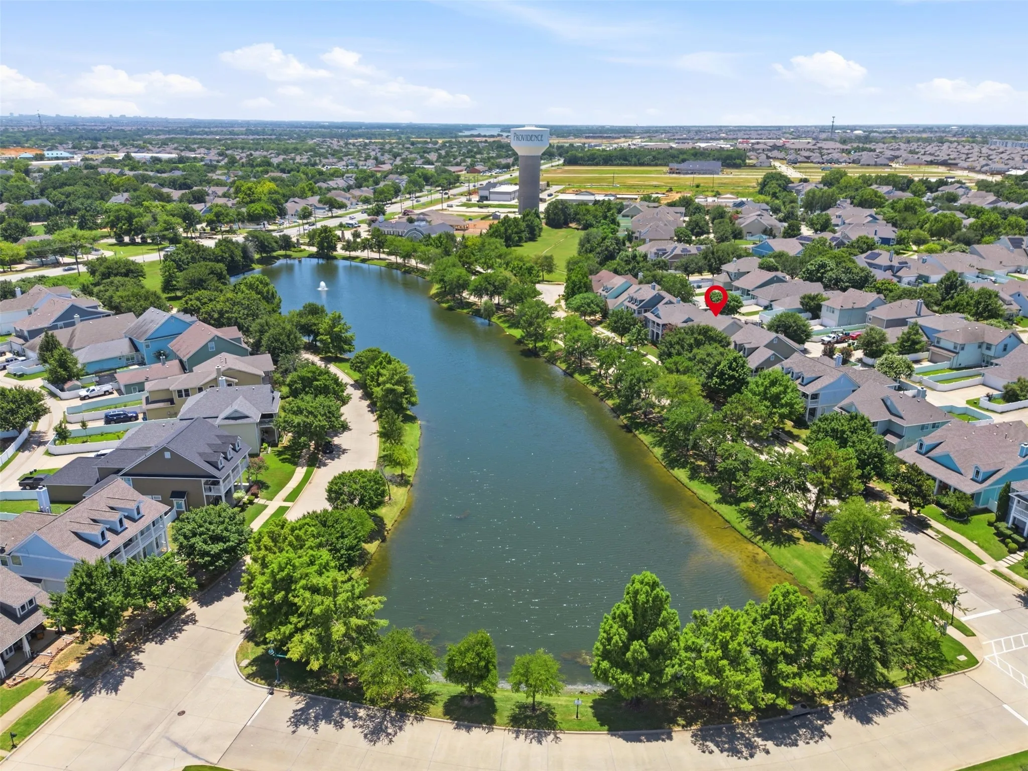 Aerial perspective showcasing a residential area with a prominent central lake feature