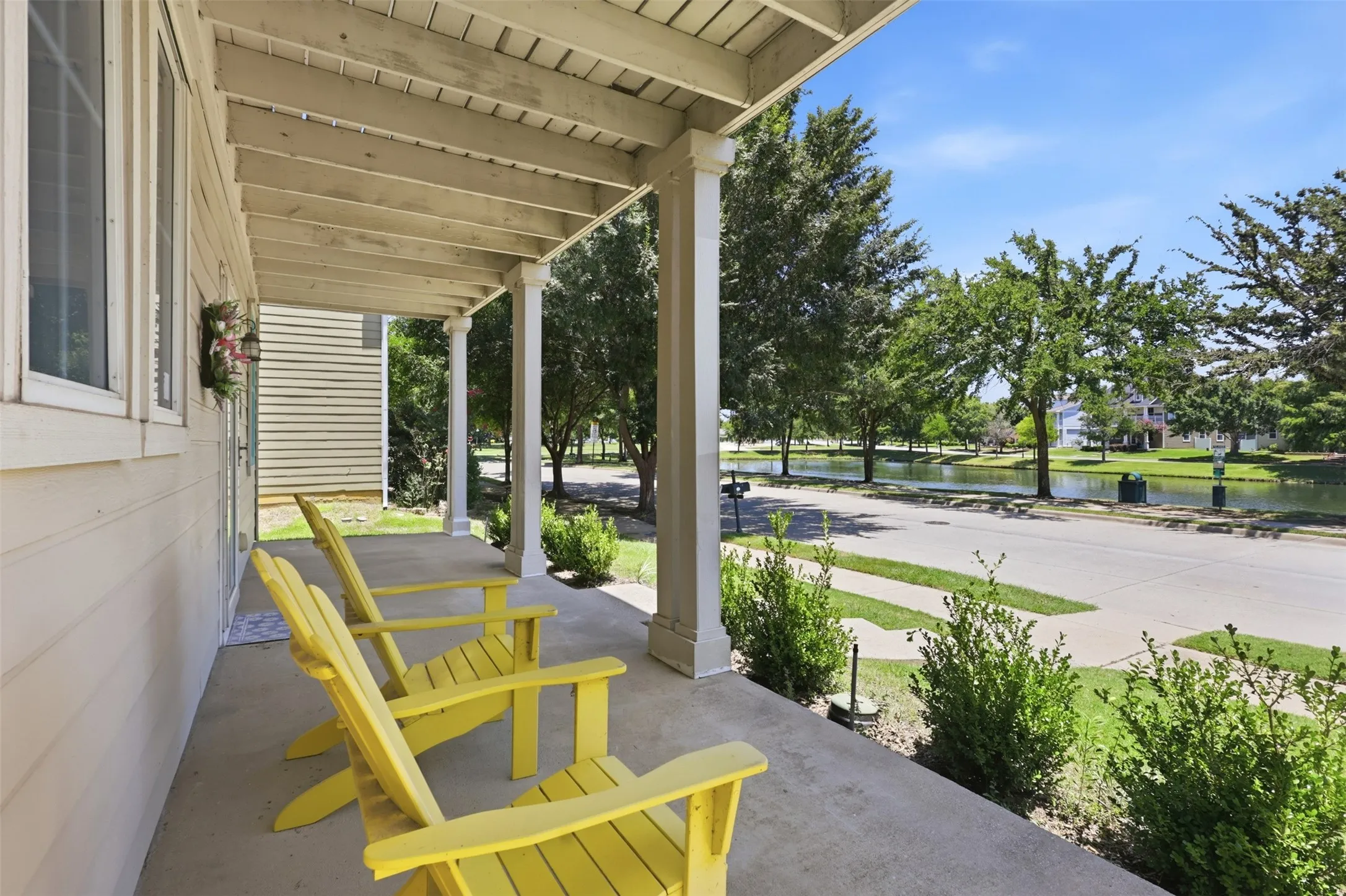 Inviting front porch with a concrete surface and substantial support columns