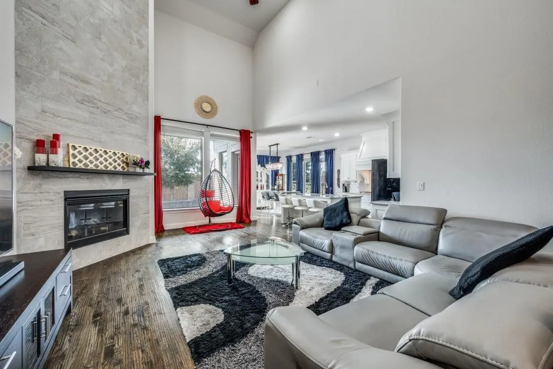 Expansive living area featuring soaring ceilings and wood-finish flooring