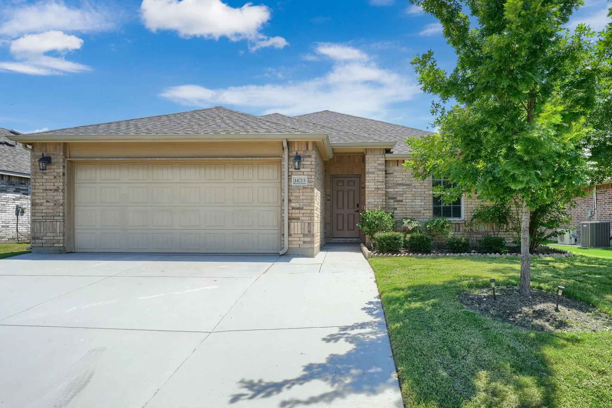 Brick and stone veneer exterior with a two-car garage