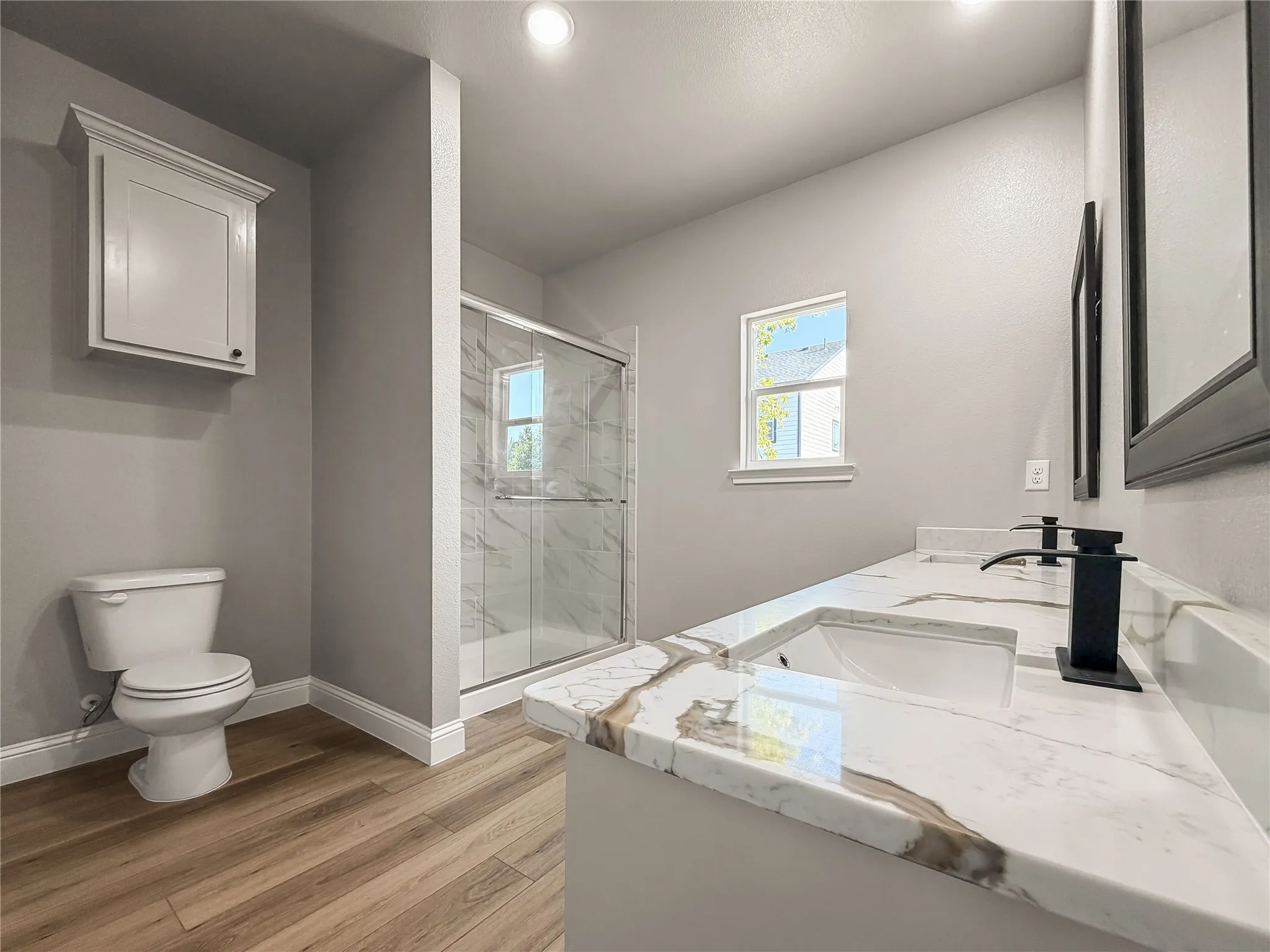 Spacious room featuring neutral carpeting and light gray walls