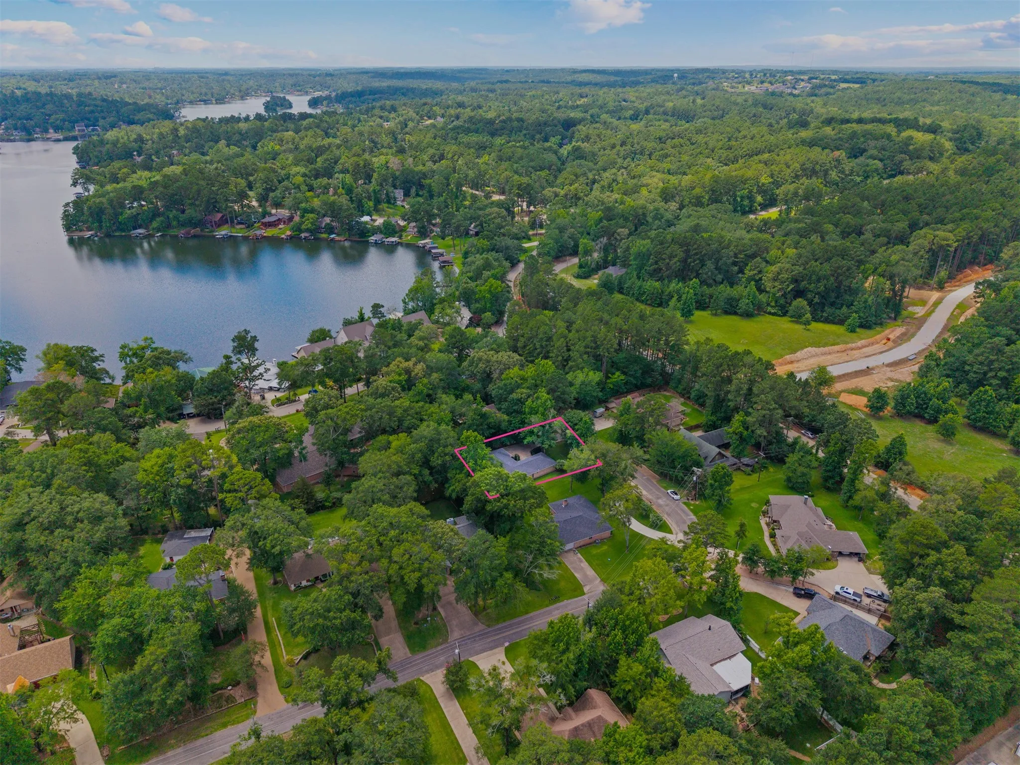 Aerial perspective showcasing a verdant landscape with a prominent lake