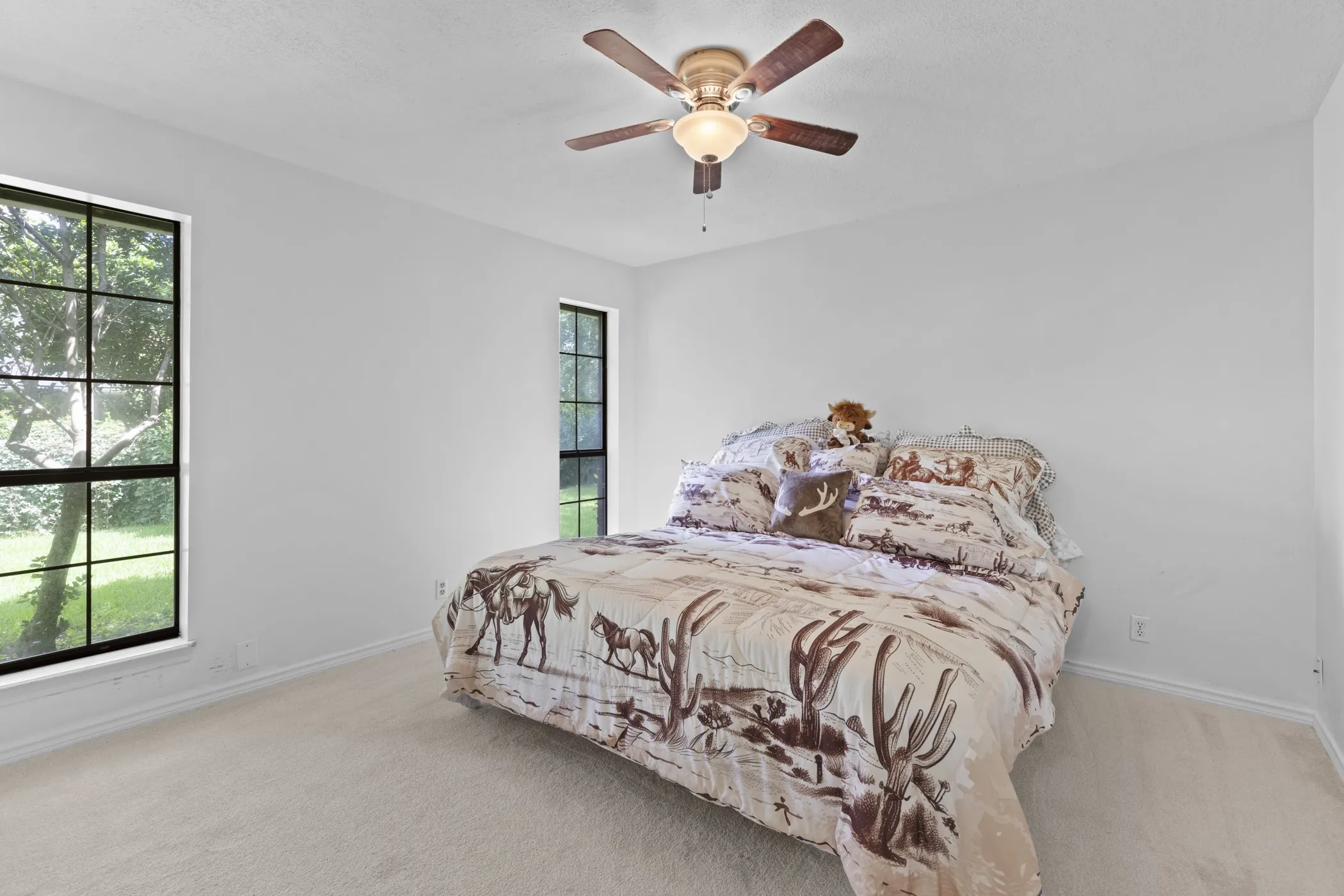 Light-toned carpeting complements the neutral wall finish
