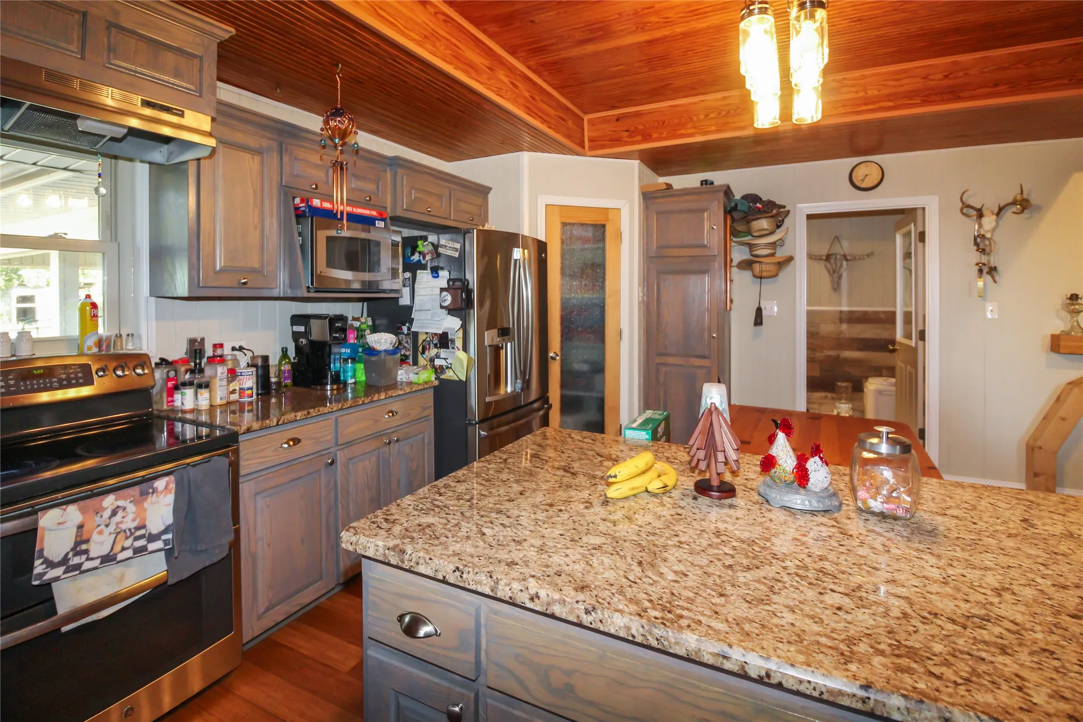 Kitchen featuring a wood plank ceiling, recessed lighting, granite countertops, stainless steel appliances, and gray-toned cabinetry