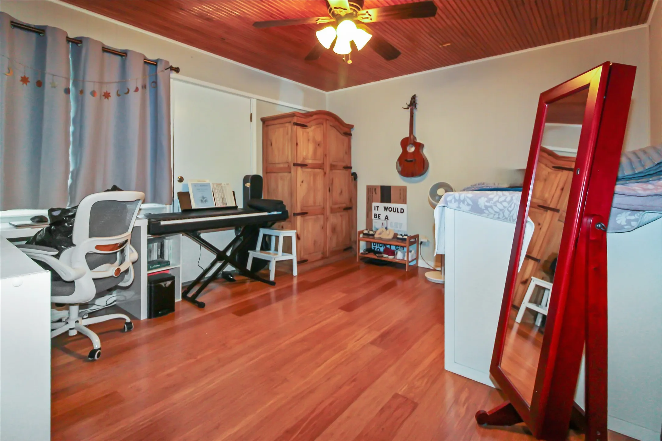 Room featuring wood-finish flooring and a wood-paneled ceiling
