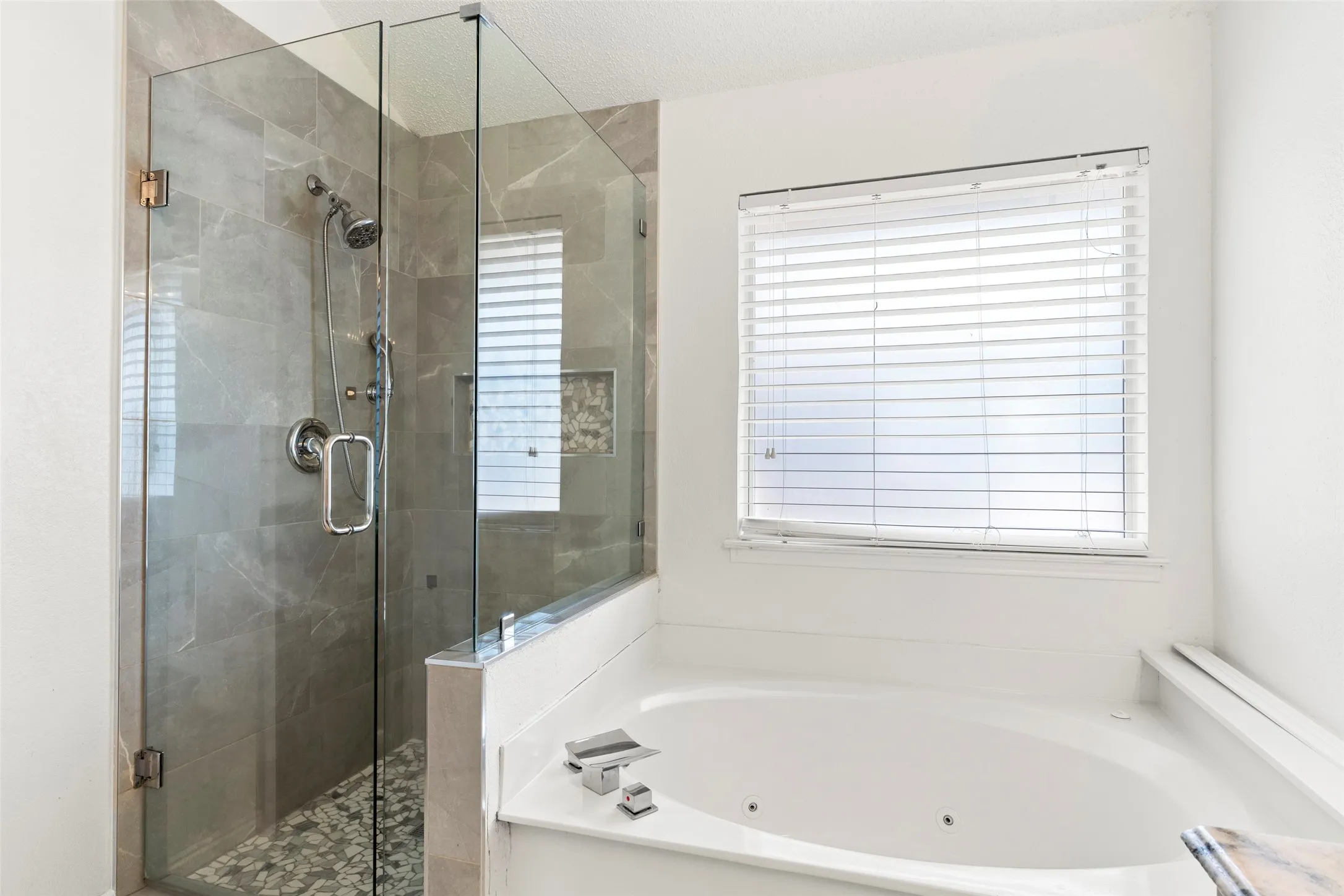 Shower enclosure with glass paneling and a tiled surround