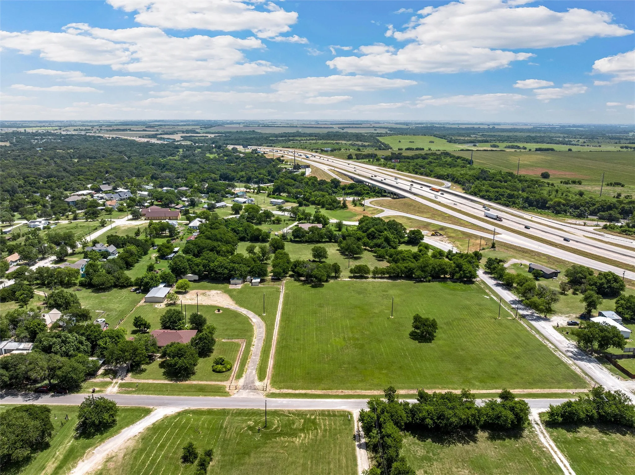 Expansive land parcel featuring open green space and trees