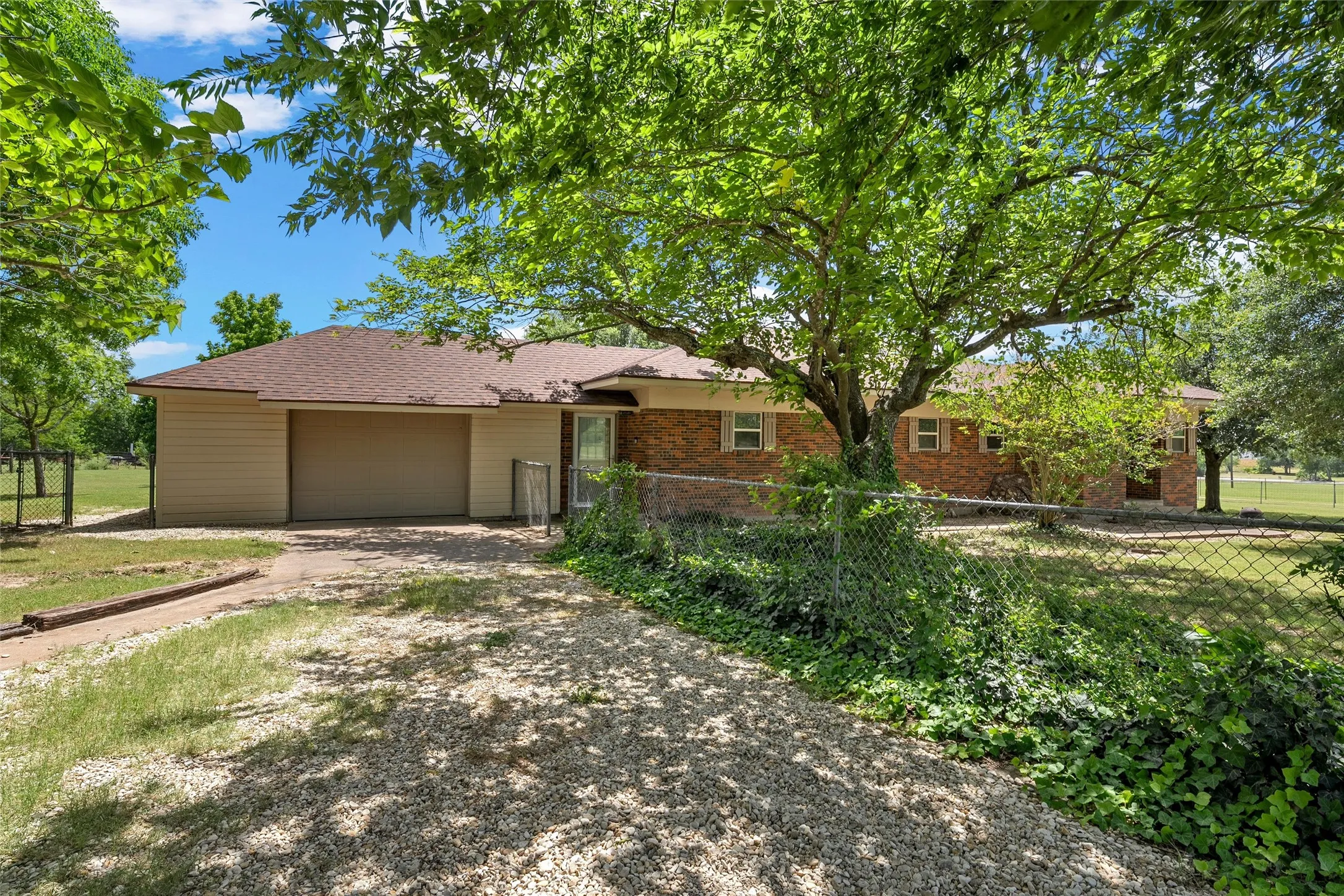 Brick and siding exterior with a brown shingle roof
