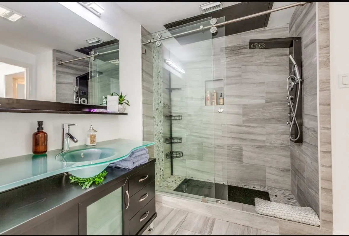 Full bathroom with vanity and a shower stall