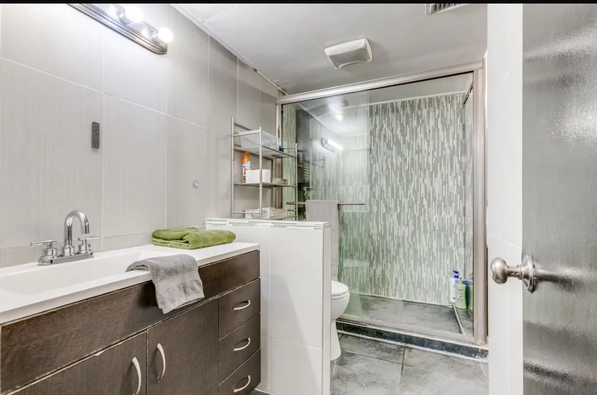 Bathroom featuring vanity, a stall shower, and light tile patterned flooring