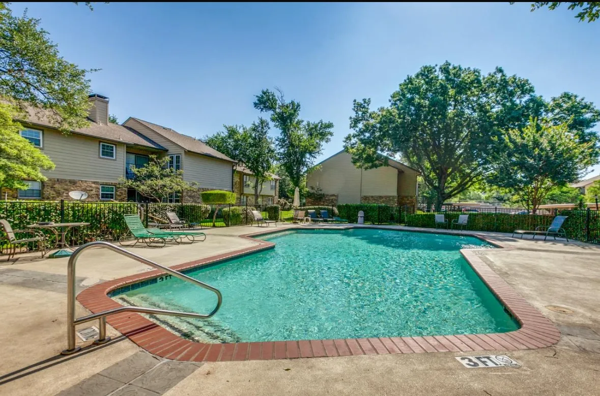 Community pool with a patio and a residential view