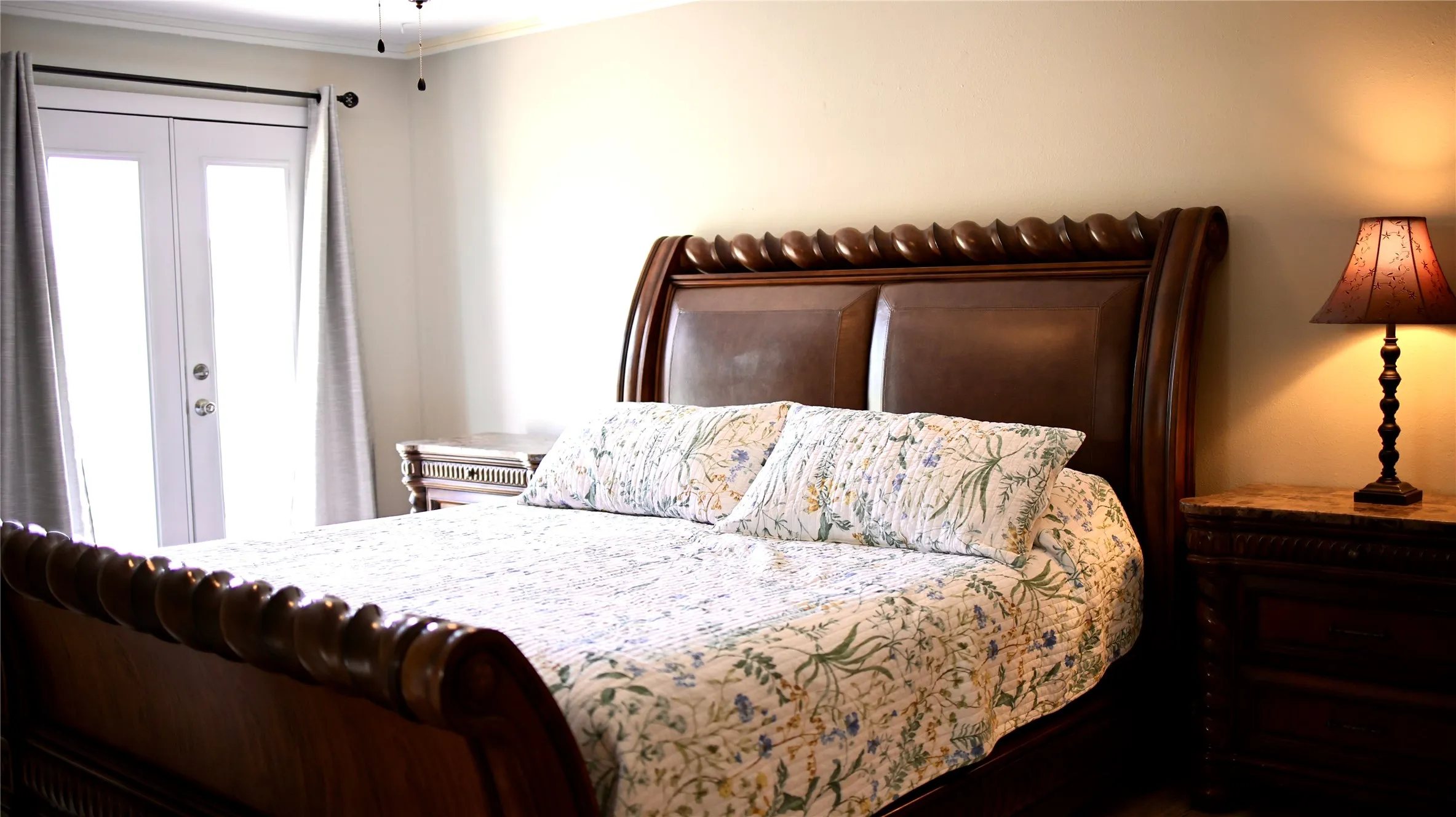 Bedroom featuring double French doors with interior blinds, crown molding, a ceiling fan, and light-toned wall paint