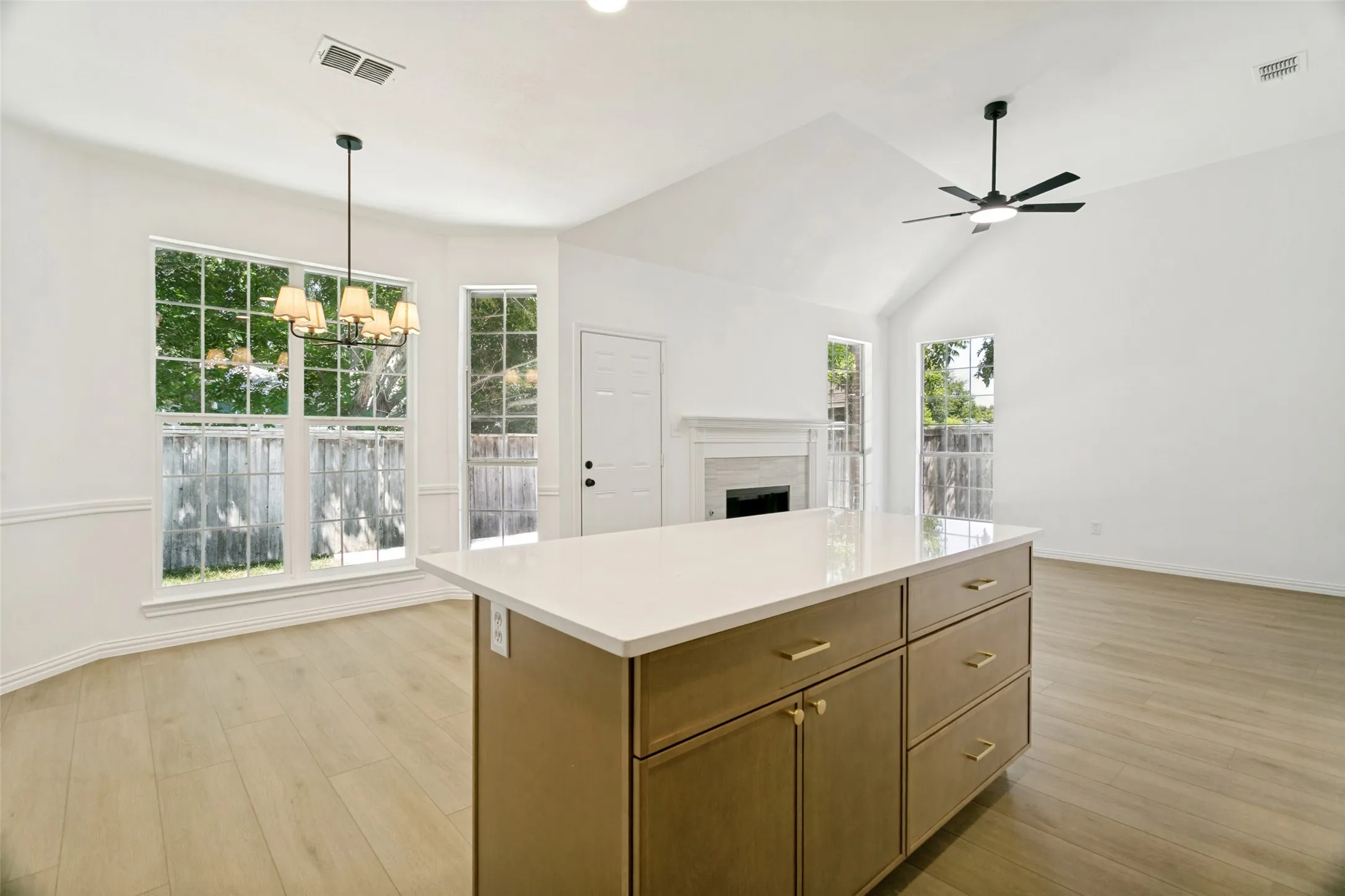 Kitchen island with white countertop and gold-tone hardware