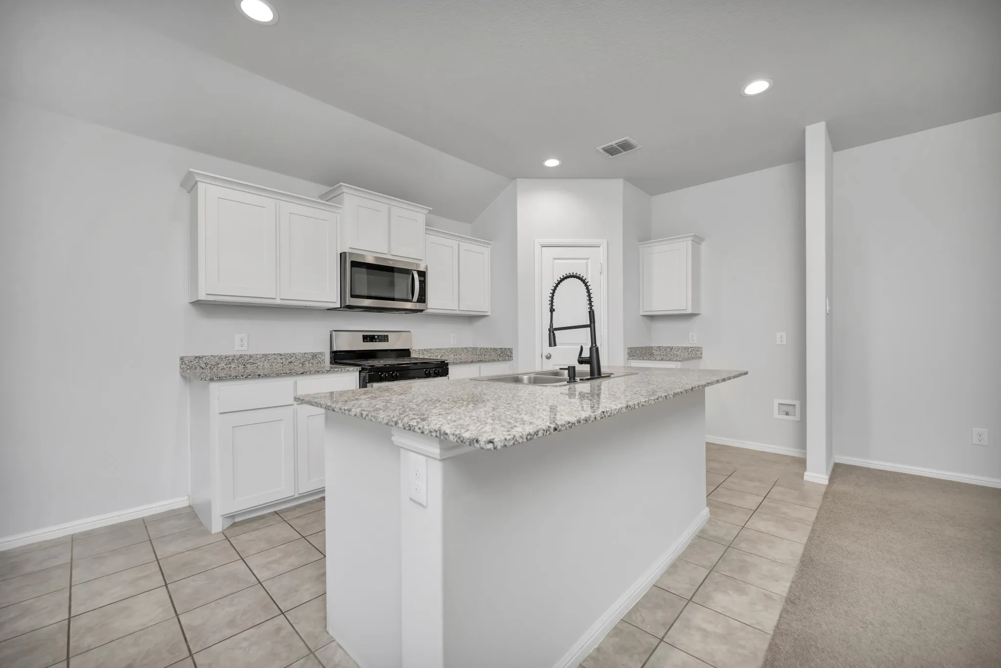Spacious kitchen with granite counter tops