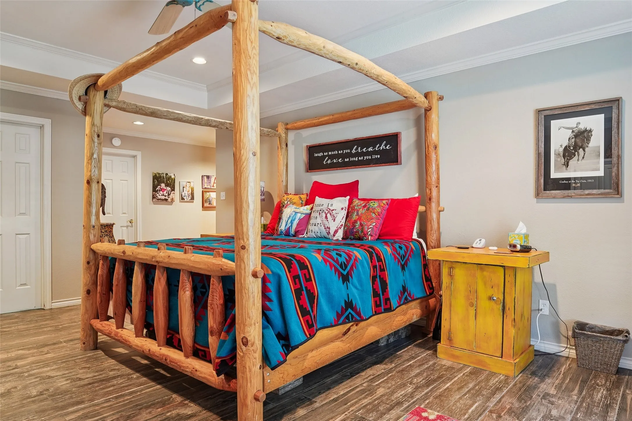 Spacious room featuring wood-finish flooring, light neutral walls, and white crown molding