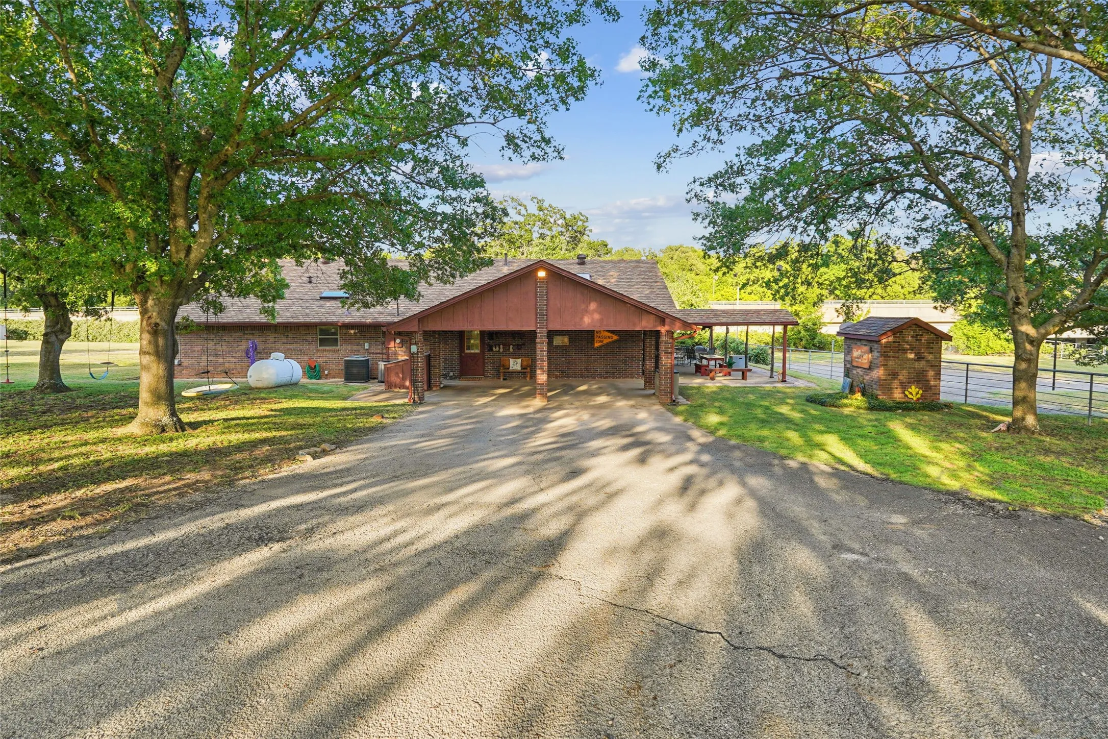 Brick exterior residence with an attached carport