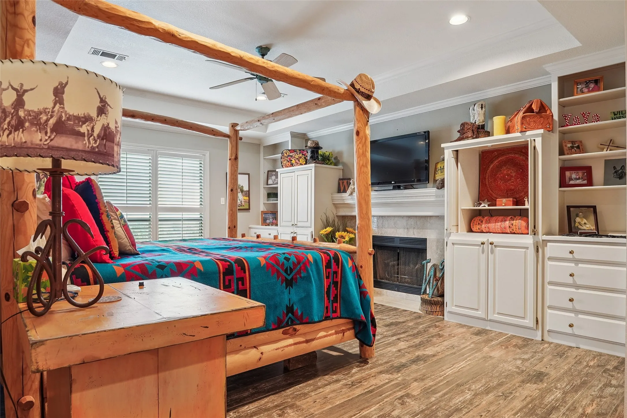 Spacious room featuring wood-finish flooring and a tray ceiling